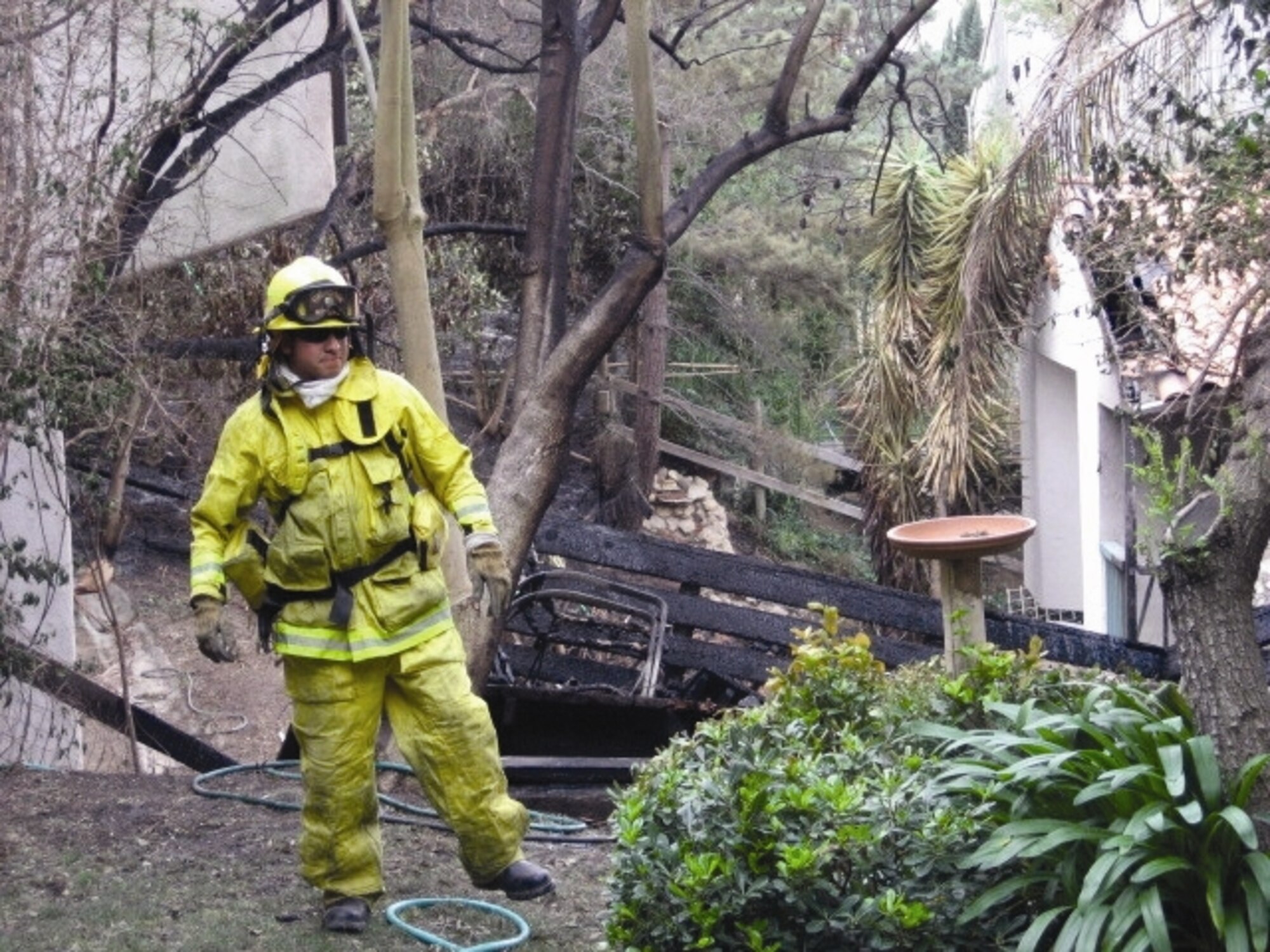 Fire fighter Dan Caballero provides structural protection at a residence in Malibu for the same fire. Four personnel from the March ARB Fire Department along with Engine-8 were sent to Malibu Nov. 8 - 10 to assist with the fires. The department, which falls under the 452nd Civil Engineering Squadron, has a dual mission supporting both the base as well as assisting the local community.  (U.S. Air Force photo)