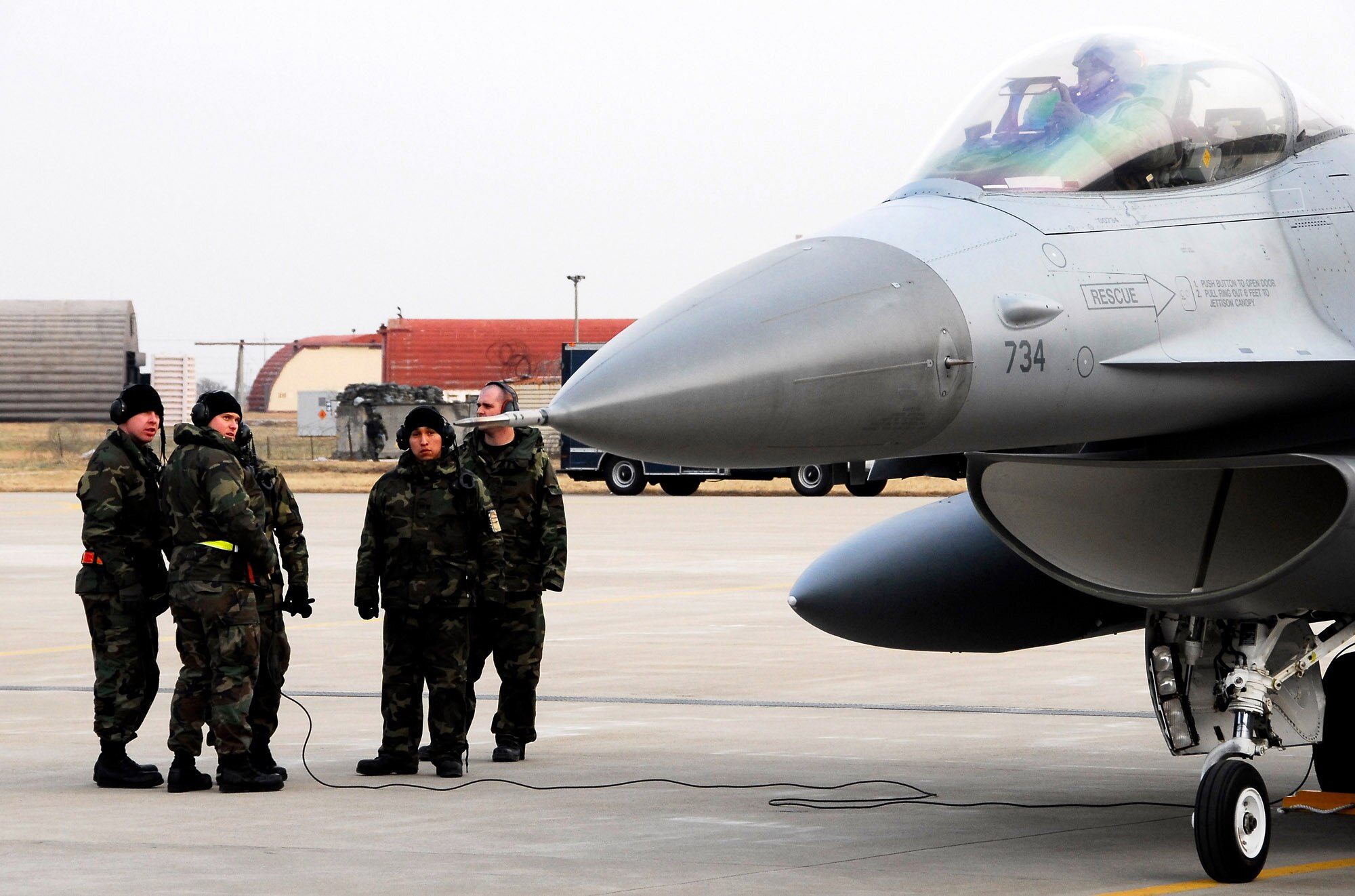Members of the 8th Aircraft Maintenance Squadron discuss in-flight errors with an 80th Fighter Squadron F-16 Fighting Falcon pilot at Kunsan Air Base, South Korea, after a Jan. 18 flight from Eielson Air Base, Alaska. The 80th Fighter Squadron will be receiving 18 Common Configuration Implementation Program Block 40 jets from the Alaskan-based unit and Eielson AFB will in-turn receive the 80th FS Block 30 jets for an aggressor squadron. (U.S. Air Force photo/Tech Sgt. Quinton T. Burris)