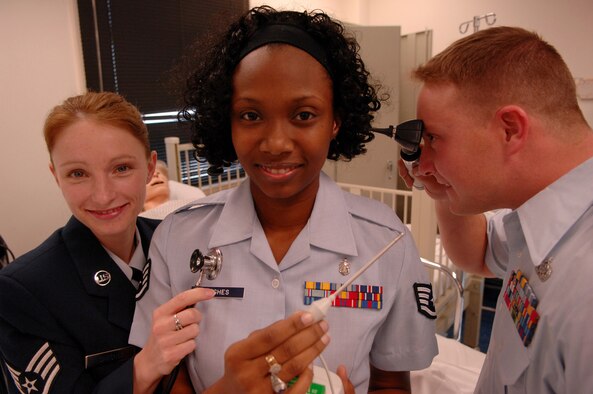 From left, Staff Sgts. Jacqlyn Sanchez, Crystal Hughes and Michael Jessup, all selected for the Nurses Enlisted Commissioning Program (NECP), make the change from Moody Air Force Base to Valdosta State University. The NECP is a program for enlisted Airmen to become commissioned nurses while maintaining active duty status. (U.S. Air Force photo by Airman 1st Class Gina Chiaverotti)