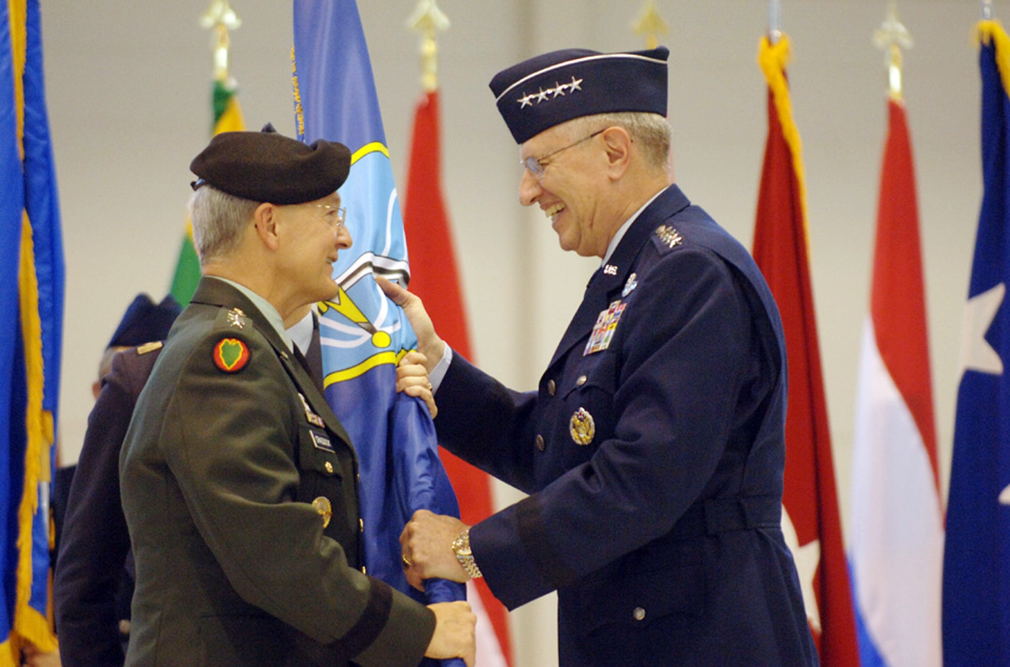 Gen. Roger A. Brady accepts the NATO Allied Air Component flag from Gen. John Craddock during the Jan. 17 assumption of command ceremony at Ramstein Air Base, Germany. As USAFE commander, General Brady also has three other titles: commander, Allied Air Component Command Ramstein; air component commander, U.S. European Command, Ramstein AB, Germany; and director, Multinational Joint Air Power Competence Center, Kalkar, Germany. General Craddock is the Supreme Allied Commander, Europe. (U.S. Air Force photo/Master Sgt. D. Scott Wagers) 
