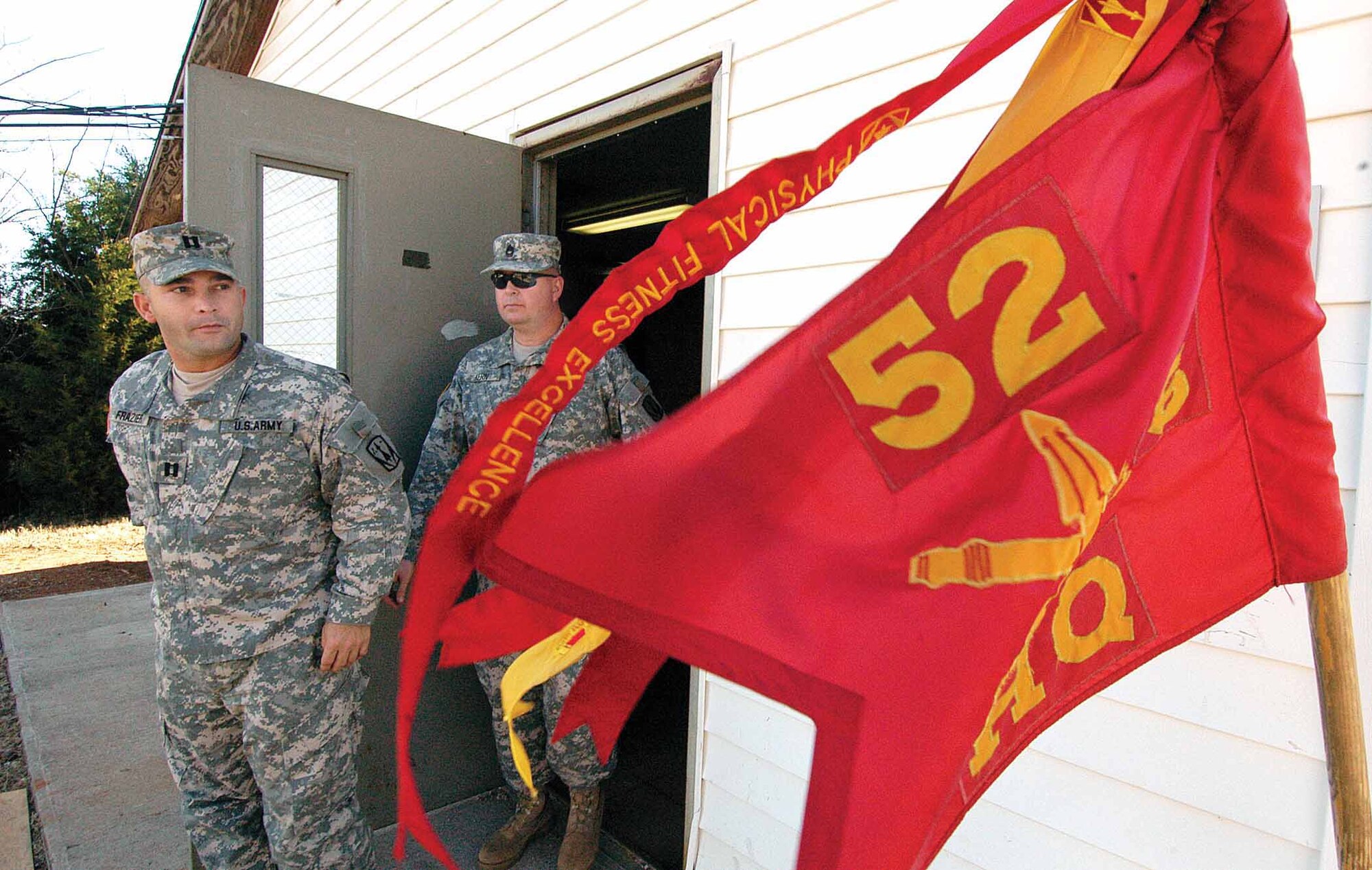 Fort Sill Soldiers leave a classroom setting at the Glenwood Training Area marked by their 6th Battalion-52nd Air Defense Artillery guidon.  Battlefield casualty and radio instruction were two subjects taught inside before hands-on training during the exercise.  (Air Force photo by Margo Wright)

