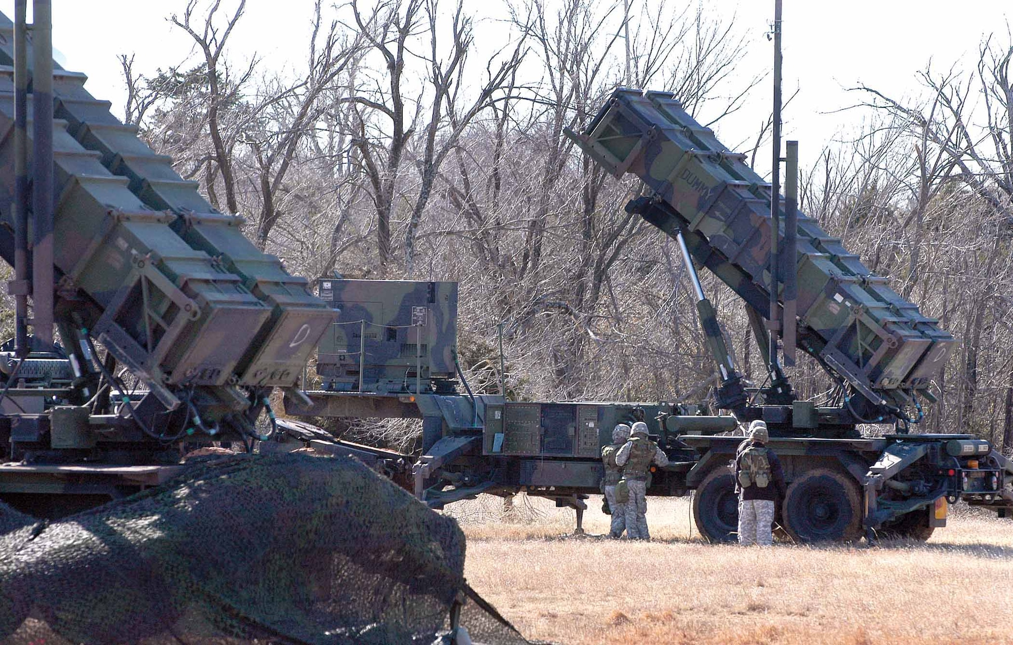 Soldiers of the 6-52nd Air Defense Artillery are dwarfed by Patriot missile launchers during the exercise.  Training with the 3rd Combat Communications Group and the 552nd Air Control Wing showed the increased war fighting capabilities achievable during conflicts.  (Air Force photo by Margo Wright)
