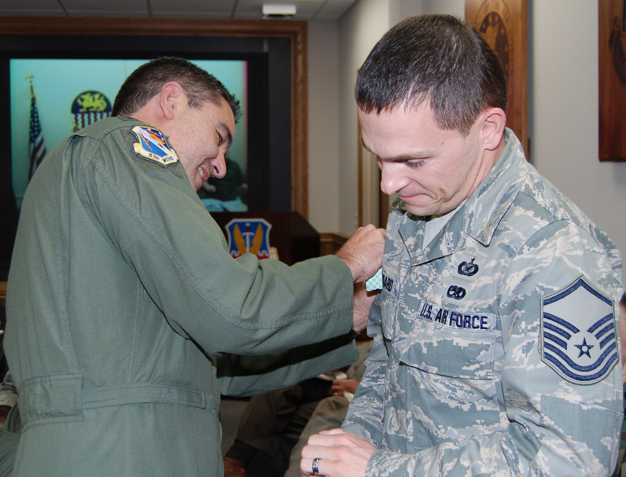 Newly promoted "Master" Sgt. Andrew Leonhard, 53d Wing public affairs, gets his stripes put on by Col. Mick Guthals, 53d Wing vice commander, at a staff meeting Jan. 14 at Eglin Air Force Base.  The new senior NCO was promoted via the Stripes for Exceptional Performers program.  Air Force photo by Capt. Carrie Kessler.