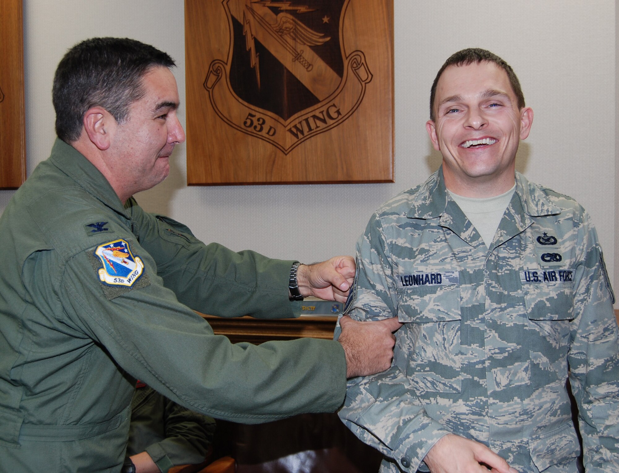 Newly promoted "Master" Sgt. Andrew Leonhard, 53d Wing public affairs, gets his stripes "tacked" on by Col. Mick Guthals, 53d Wing vice commander, at a staff meeting Jan. 14 at Eglin Air Force Base.  The new senior NCO was promoted via the Stripes for Exceptional Performers program.  Air Force photo by Capt. Carrie Kessler.