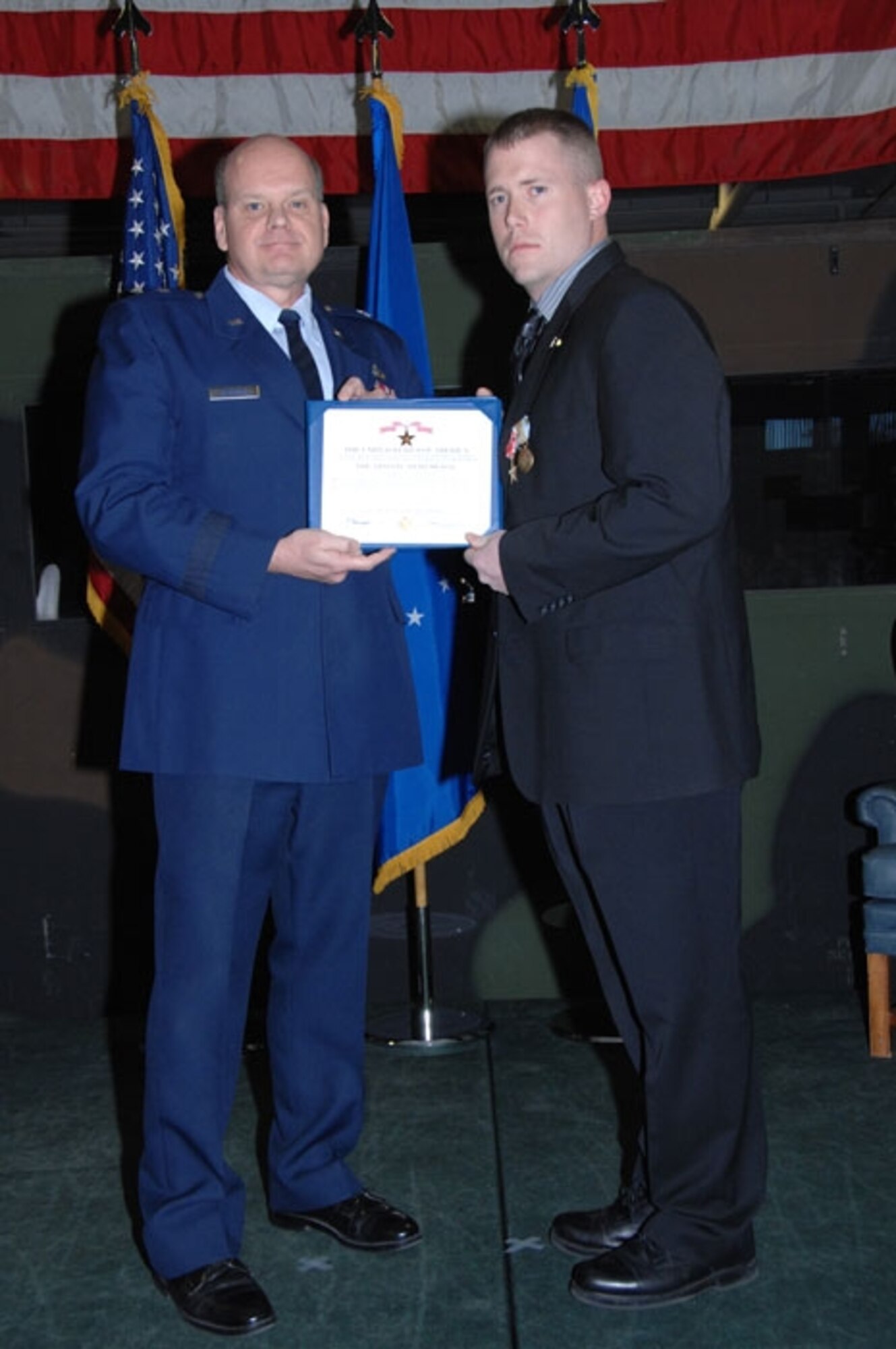Brig. Gen. Dana Simmons, Air Force Office of Special Investigations commander, presents Special Agent James Collins with the Airman’s Medal Jan. 15. Special Agent Collins received the Airman’s Medal for heroism and his selfless actions in helping evacuate and save troops from a U.S. Marine C-46 Sea Knight helicopter that crashed in Iraq. (U.S. Air Force photo/ Master Sgt. Wendy Weidenhamer)

