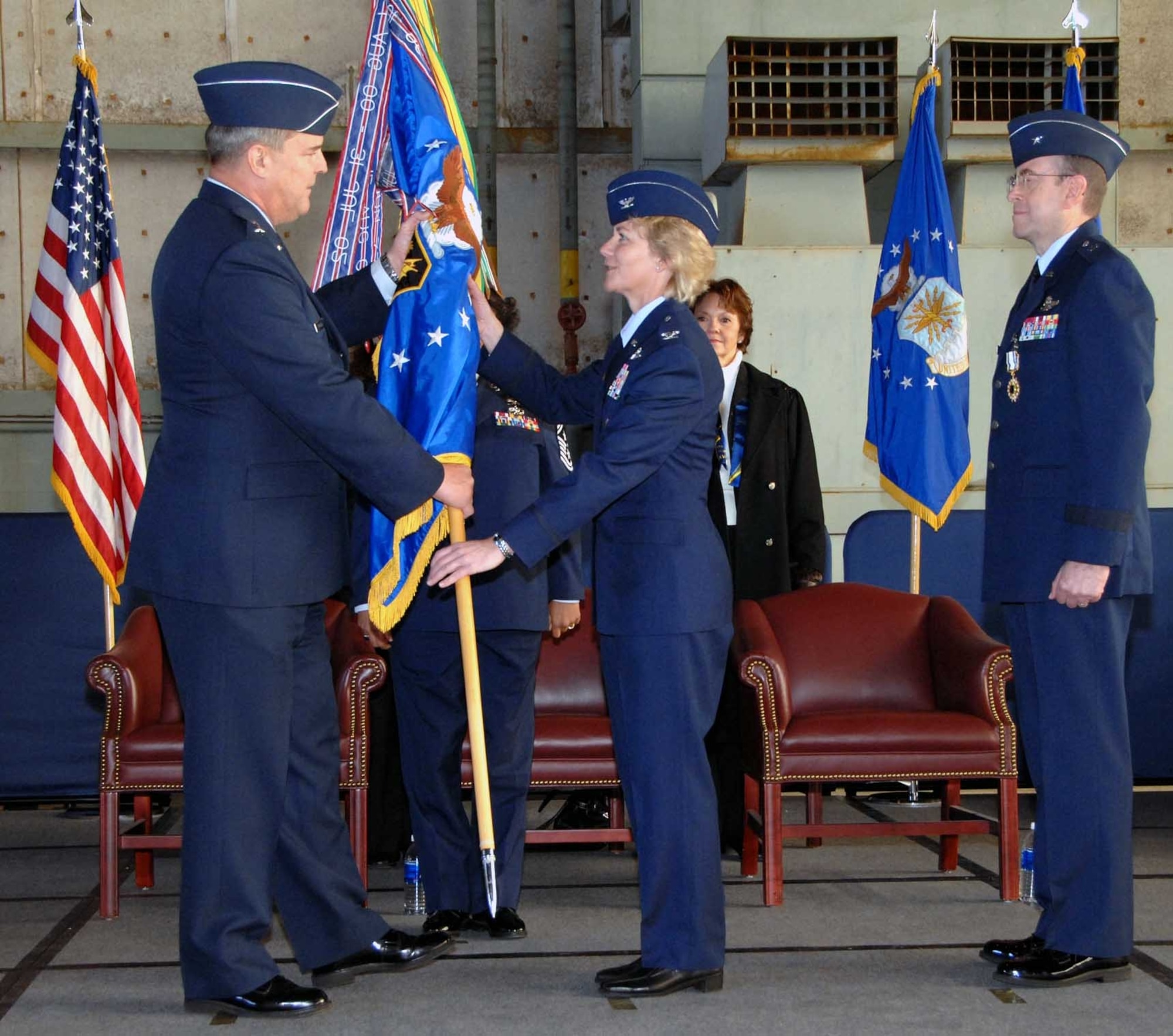 Col. Maryanne Miller assumes command of the 349th Air Mobility Wing from Brig. Gen. Thomas Gisler Jan. 13 in Hangar 818. Colonel Miller is presented the Air Force Reserve flag by Maj. Gen. Robert Duignan, 4th Air Force commander. Colonel Miller is the 22nd and first female commander of the 349th AMW. (U.S. Air Force photo/Master Sgt. Wendy Weidenhamer)