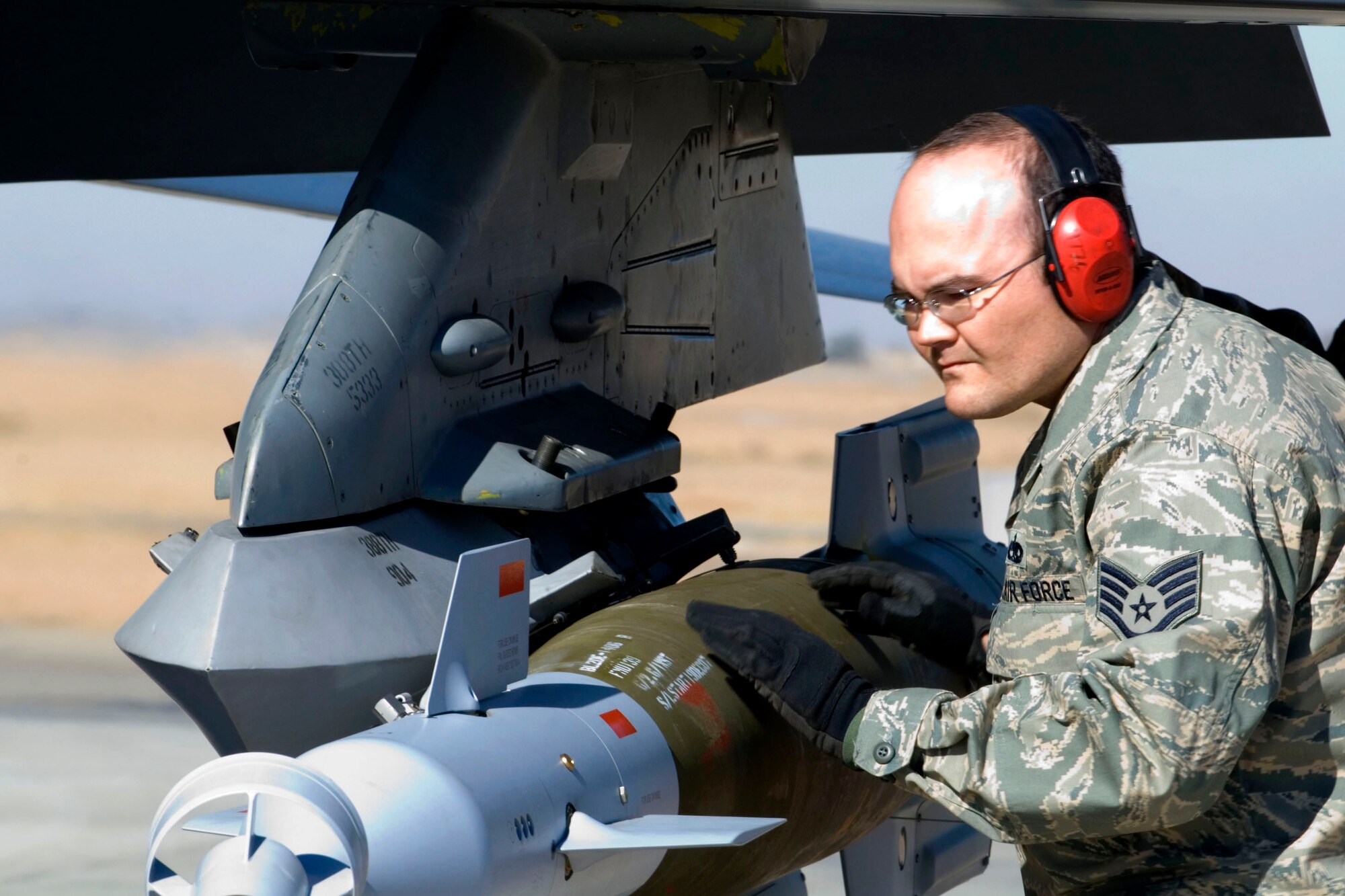 Staff Sgt. Michael Norton inspects a guided bomb unit on an F-16 Fighting Falcon Jan. 16 at Balad Air Base, Iraq. Aircraft are armed prior to taking the runway for takeoff. Sergeant Norton, a 332nd Expeditionary Maintenance Squadron aircraft armament specialist, is deployed from Hill Air Force Base, Utah. (U.S. Air Force photo/Staff Sgt. Joshua Garcia) 
