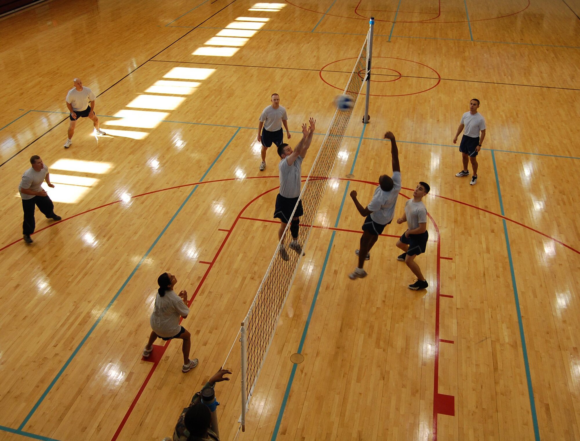 A member of the First Term Airman Class players spikes the ball over the net during a friendly volleyball game between the Top 3 team and the FTAC team Jan. 16 at the Losano Fitness Center gym. Though, the undefeated Top 3 team was leading from the start, the game was cut short due to an injury.  The Top 3 versus FTAC volleyball game is organized to build esprit de corps and to acquaint new Airmen with their enlisted leaders at Laughlin. (U.S. Air Force photo by Senior Airman Olufemi Owolabi)
