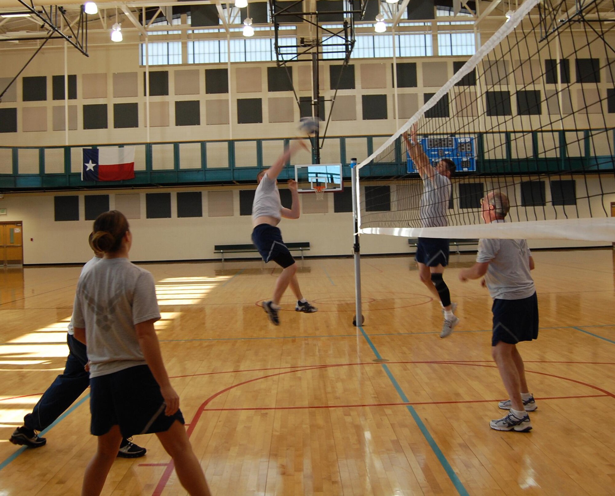 A member of the Top 3 players spikes the ball over the net during a friendly volleyball game between the Top 3 team and the First Term Airman Class team Jan. 16 at the Losano Fitness Center gym. Though, the undefeated Top 3 team was leading from the start, the game was cut short due to an injury.  The Top 3 versus FTAC volleyball game is organized to build esprit de corps and to acquaint new Airmen with their enlisted leaders at Laughlin. (U.S. Air Force photo by Senior Airman Olufemi Owolabi)