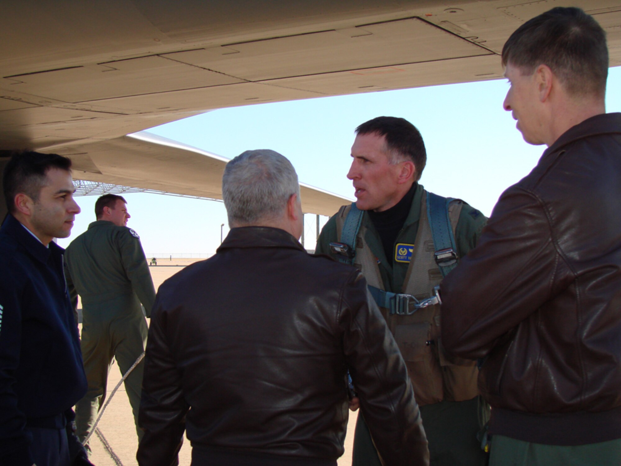 Col. Scott Vander Hamm, 28th Bomb Wing commander, chats with Command Chief Master Sgt. Ruben Gonzalez, 71st Flying Training Wing Vice Commander Col. Rod Gilis and 71st FTW Commander Col. Richard Klumpp Jr. after landing at Vance Jan. 17.  Colonel Vander Hamm is the graduation guest speaker for Class 08-04.  (U.S. Air Force photo by Tech. Sgt. Mary Davis)