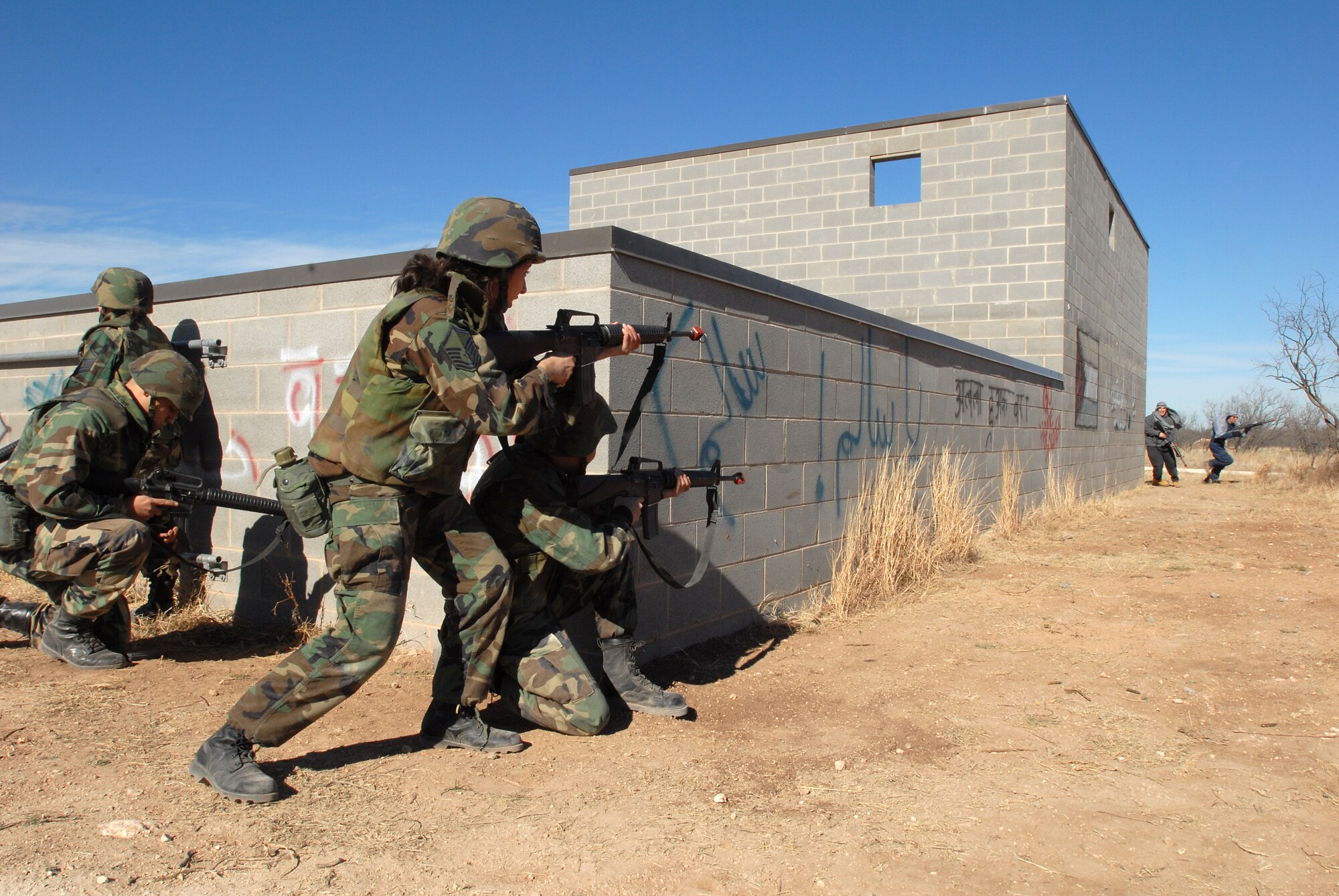 ROTC cadets storm the training building at Camp Sentinel. (U.S. Air Force Photos by Tech. Sgt. Gina O’Bryan)