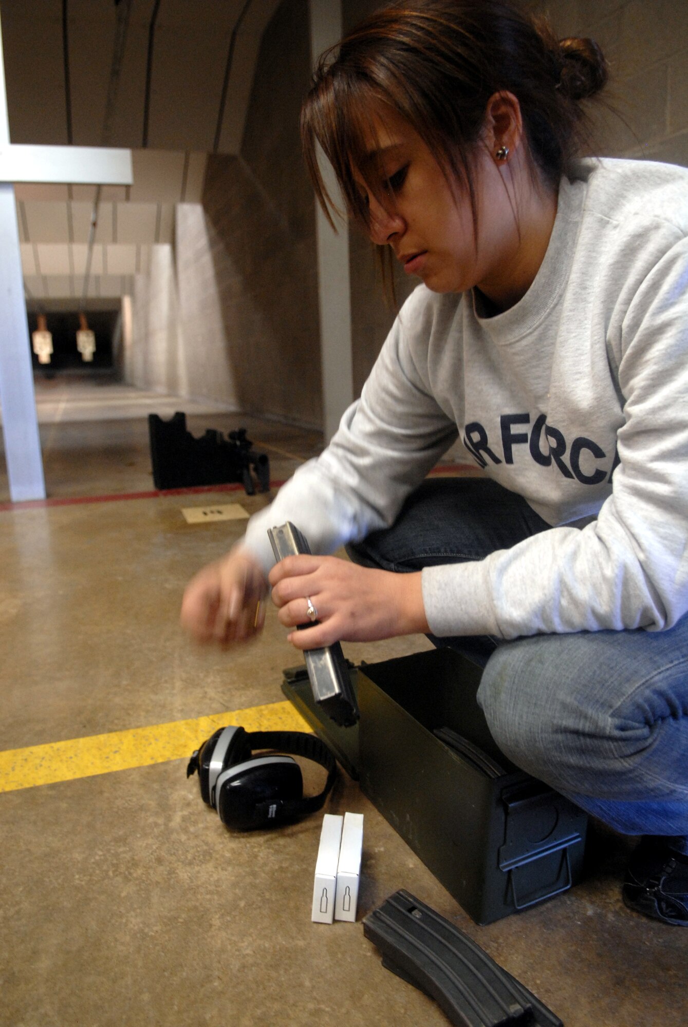 Cadet Nicole Solorzano loads a magazine during fire arms training at the base firing range. The cadets trained on the use of fire arms, proper procedures, and various firing positions, including the prone supported, prone unsupported, kneeling supported and over-barricade supported. (U.S. Air Force photo by Airman 1st Class Kamaile Chan)