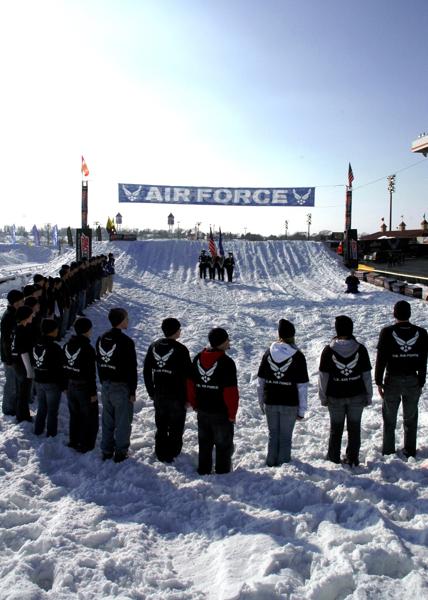 Thirty-four Air Force Delayed Enlistment Program members watch as the Air Force Honor Guard posts the colors at a SnoCross event in Shakopee, Minn., Jan. 12. During a break in the action later, the 34 young men and women took the oath of enlistment in front of a crowd of more than 25,000 spectators. (Courtesy photo) 
