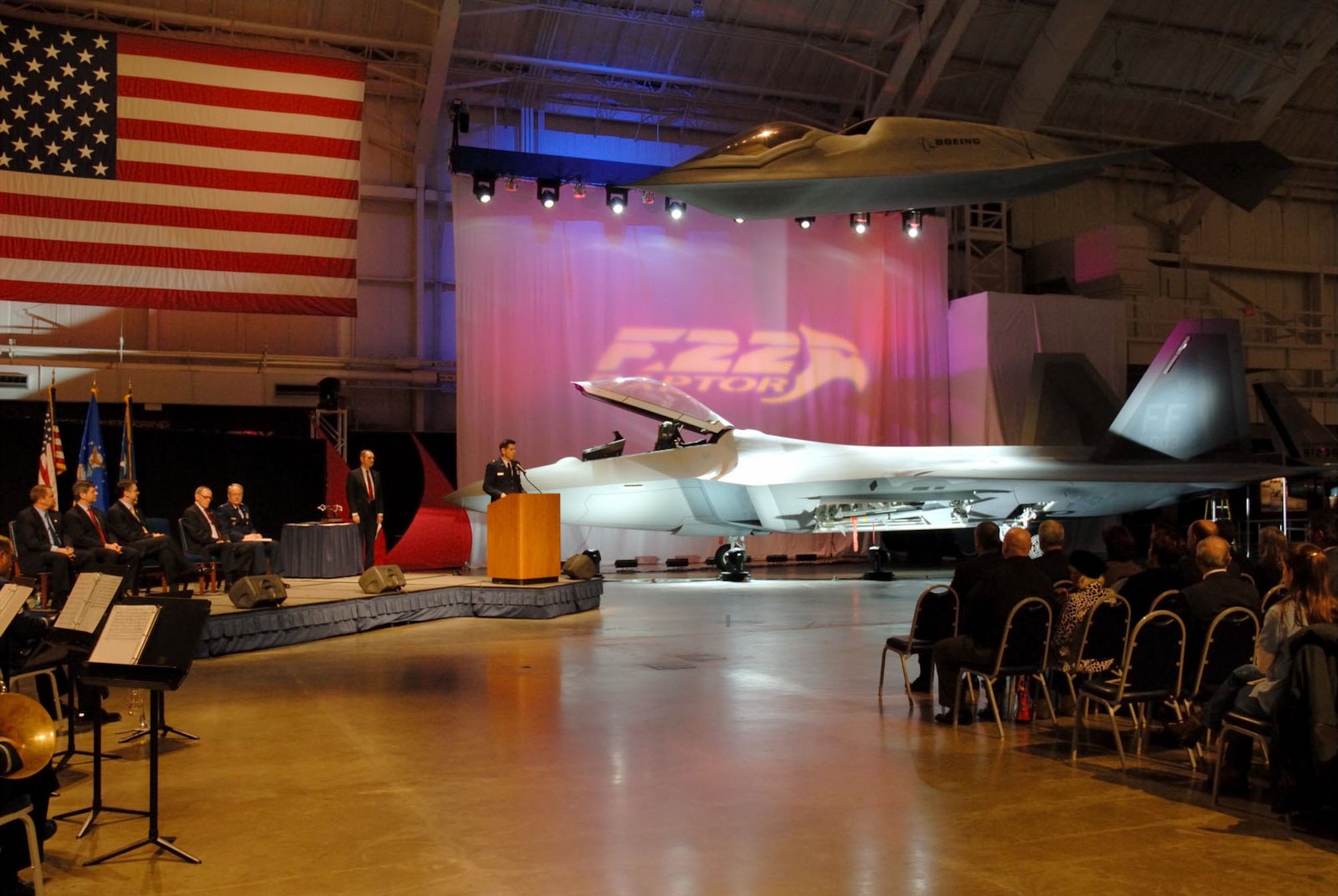 DAYTON, Ohio (1/17/08) - Brig. Gen. C.D. Moore, Commander, 478th Aeronautical Systems Wing at Wright-Patterson Air Force Base, addresses the crowd during the F-22A Raptor exhibit opening ceremony at the National Museum of the U.S. Air Force. Seated on stage (from left to right) are Mr. Chris Flynn, Director of the F119 Program for Pratt & Whitney; Mr. Paul J. Bay, Vice President and Program Manager of the F-22 Program for the Boeing Company; Mr. Larry Lawson, Executive Vice President and General Manager of the F-22 Program for Lockheed Martin; Maj. Gen. (Ret.) Charles D. Metcalf, Director of the National Museum of the U.S. Air Force; and Lt. Gen. Frank G. Klotz, Assistant Vice Chief of Staff and Director of Air Force Staff.  (U.S. Air Force photo) 