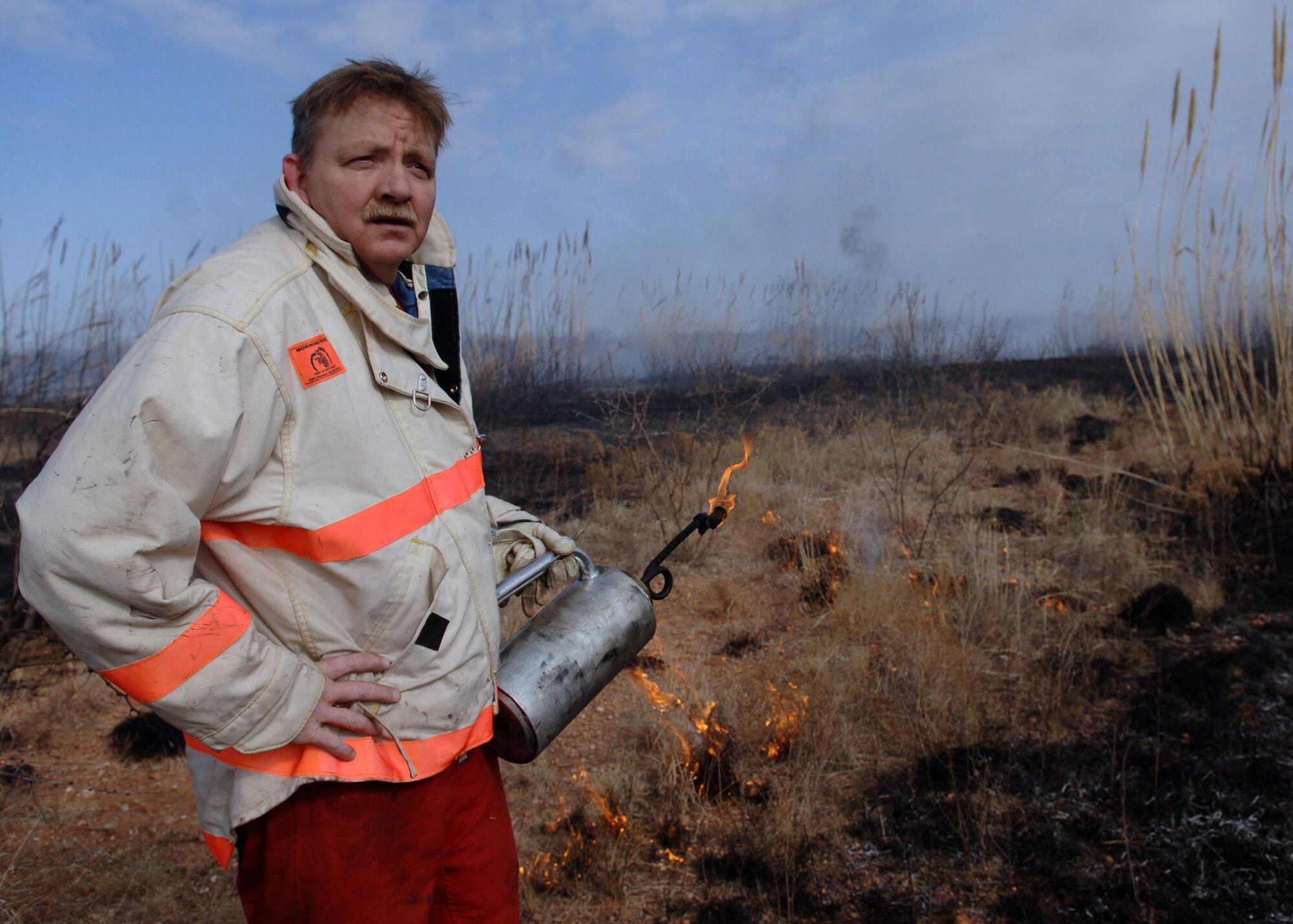 DYESS AFB, Tx-- Deputy Fire Chief Mr. Floyd Jones gazes upon one-hundred and fifteen acres of smoldering land, Jan 17. The Dyess fire department sets off controlled burns such as these in order to prevent fires that are uncontrolled. (U.S. Air Force photo by Airman 1st Class Micheal Breaux)
