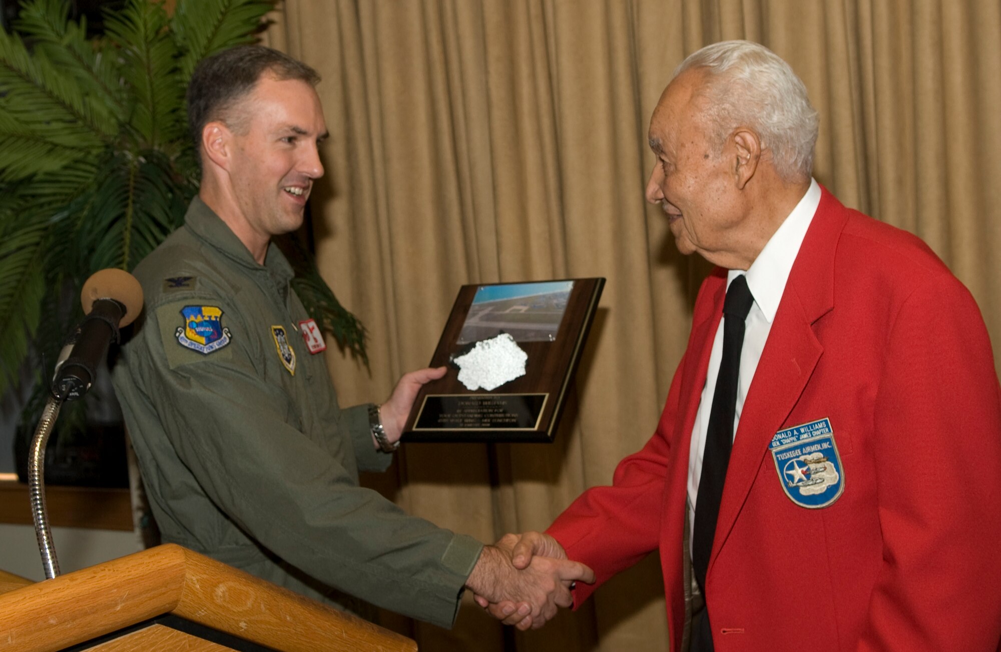 45th Operations Group Commander Col. Bernard Gruber presents Donald Williams with a piece of Patrick AFB runway as a token of thanks for speaking at the 45th Space Wing’s Martin Luther King Jr. memorial luncheon Tuesday at The Tides. (U.S. Air Force photo by Jim Laviska)
