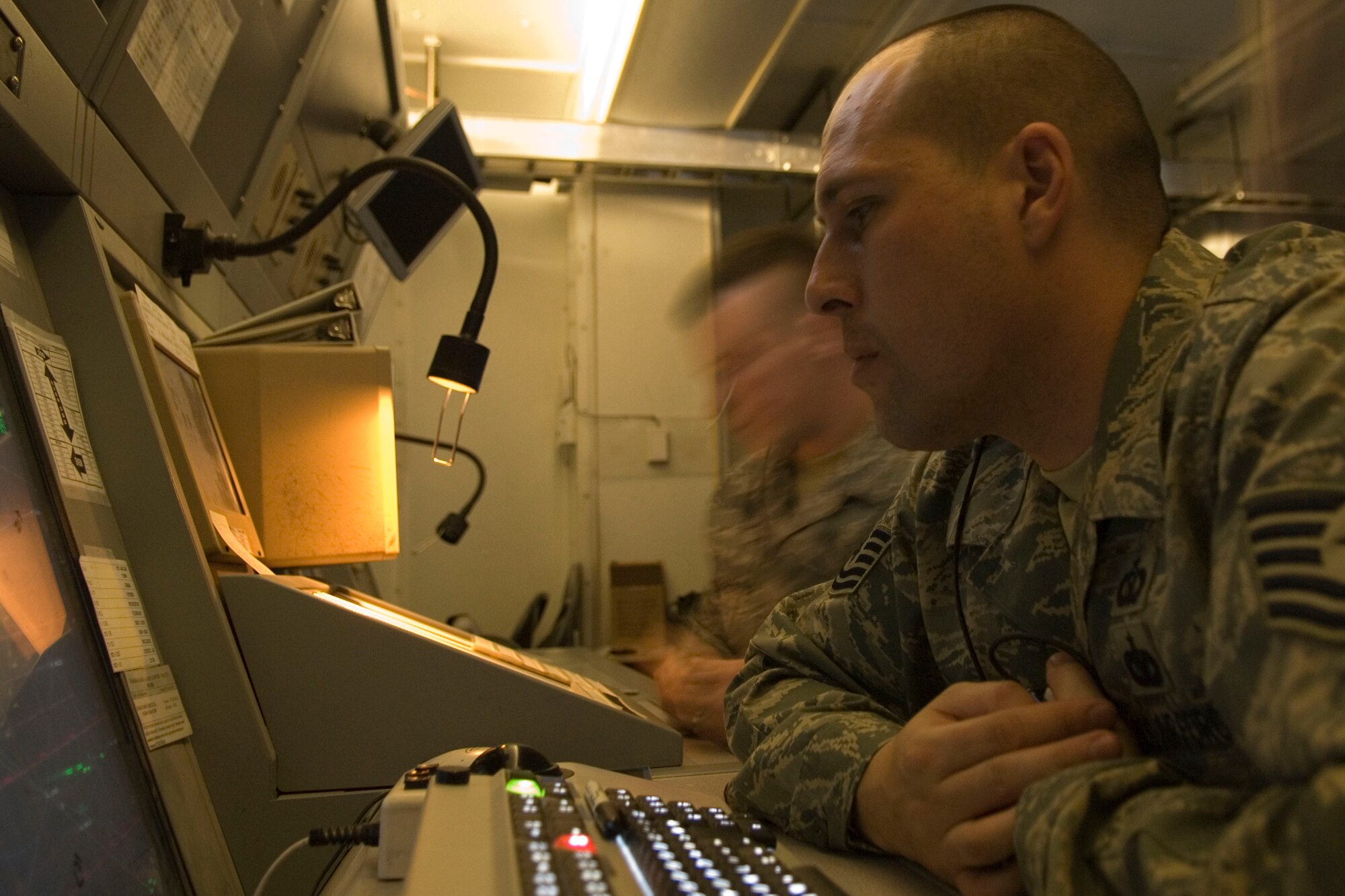 BALAD AIR BASE, Iraq -- Tech. Sgt. Russell Tomei, a 332nd Expeditionary Operation Support Squadron air traffic controller, communicates here with aircraft over the skies of Iraq, Jan. 18. Air traffic controllers have the capability to communicate and control routes for multiple aircraft simultaneously. Sergeant Tomei is deployed from Travis Air Force Base, Calif. (U.S. Air Force photo/Staff Sgt. Joshua Garcia)