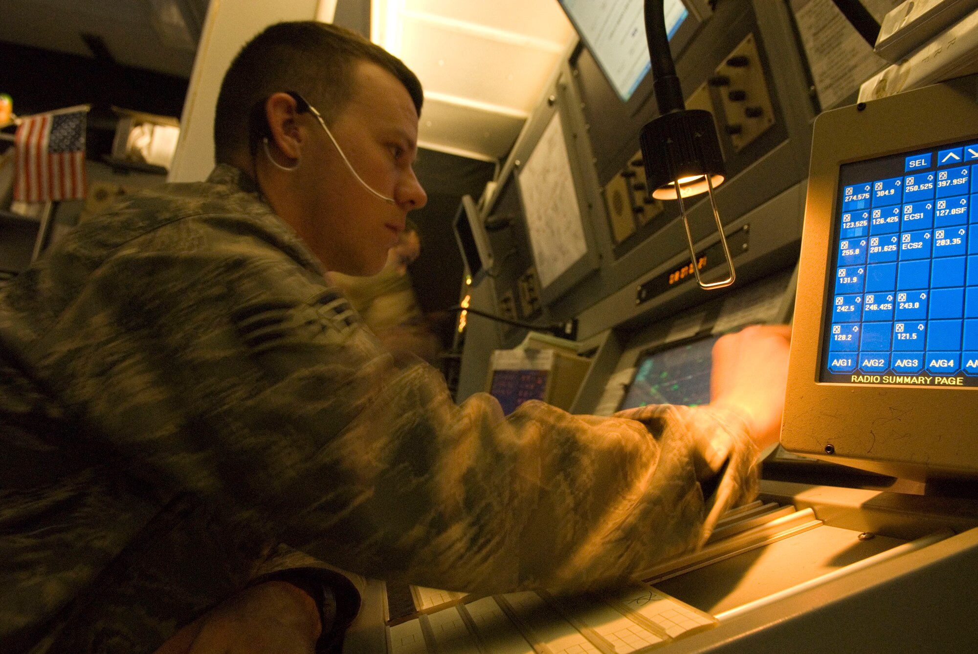 BALAD AIR BASE, Iraq -- Senior Airman Doug Richardson, a 332nd Expeditionary Operation Support Squadron air traffic controller, aids the center controller from the center assist controller seat as they monitor aircraft here, Jan. 18. The assist controller communicates with forwarding operating bases throughout Iraq, allowing the center controller to focus on communications with aircraft. Airman Richardson is deployed from Luke Air Force Base, Ariz. (U.S. Air Force photo/Staff Sgt. Joshua Garcia)