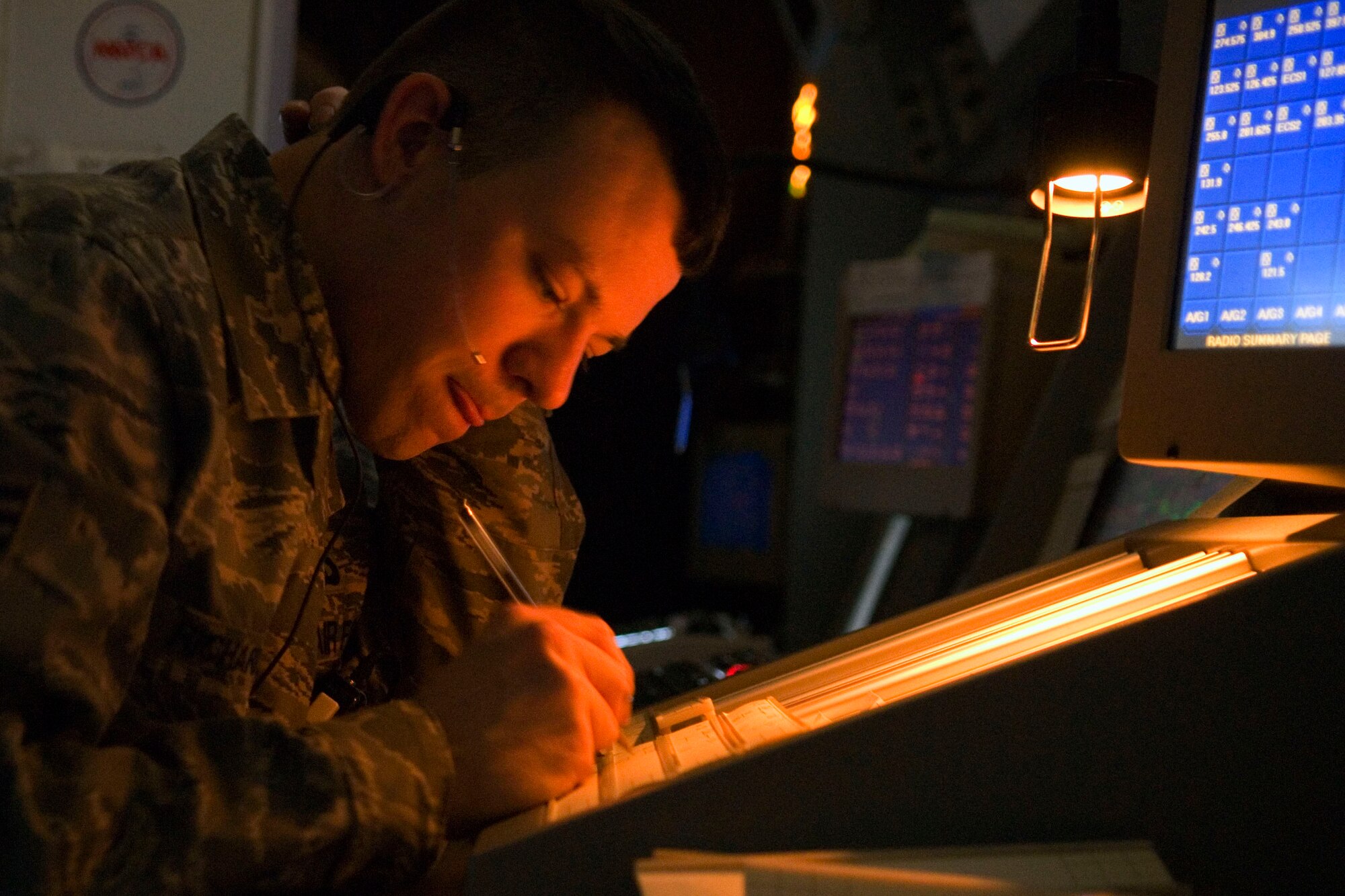 BALAD AIR BASE, Iraq -- Senior Airman Doug Richardson, a 332nd Expeditionary Operation Support Squadron air traffic controller, documents aircraft movement here, Jan. 18. Air traffic controllers stationed at Balad help manage air traffic throughout the area of responsibility. Airman Richardson is deployed from Luke Air Force Base, Ariz. (U.S. Air Force photo/Staff Sgt. Joshua Garcia)