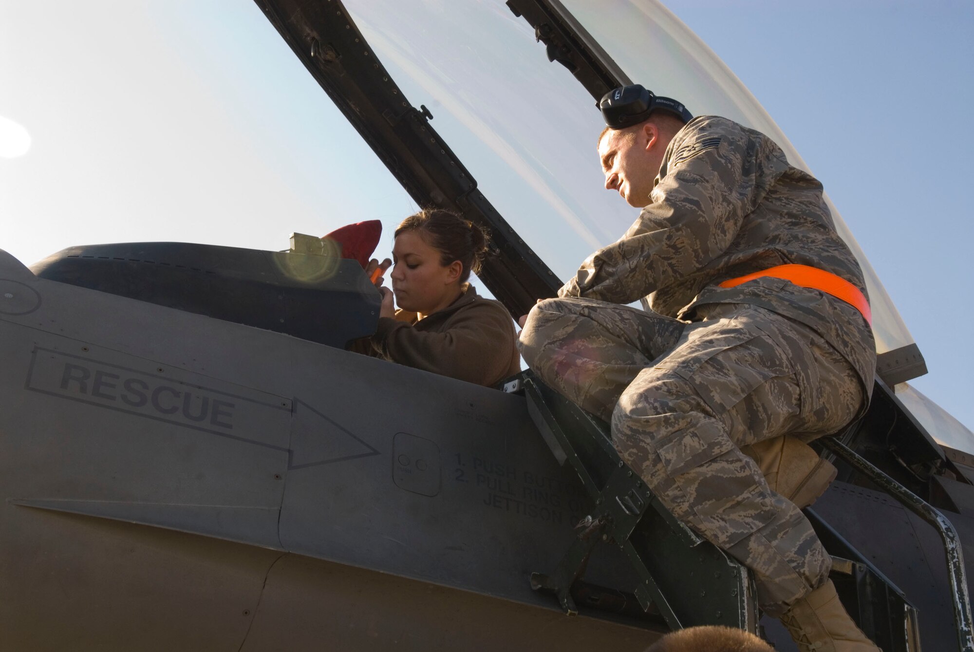 BALAD AIR BASE, Iraq -- Senior Airman Renee Hoover, a 332nd Expeditionary Aircraft Maintenance Unit crew chief, installs an F-16 Fighting Falcon Integrated Control Panel as Staff Sgt. Clint Sickel, a 332nd Expeditionary Maintenance Group quality assurance technician, observes her performance during a personnel evaluation here, Jan. 17. Airman Hoover and Sergeant Sickel are deployed from Spangdahlem Air Base, Germany. (U.S. Air Force photo/Staff Sgt. Joshua Garcia)