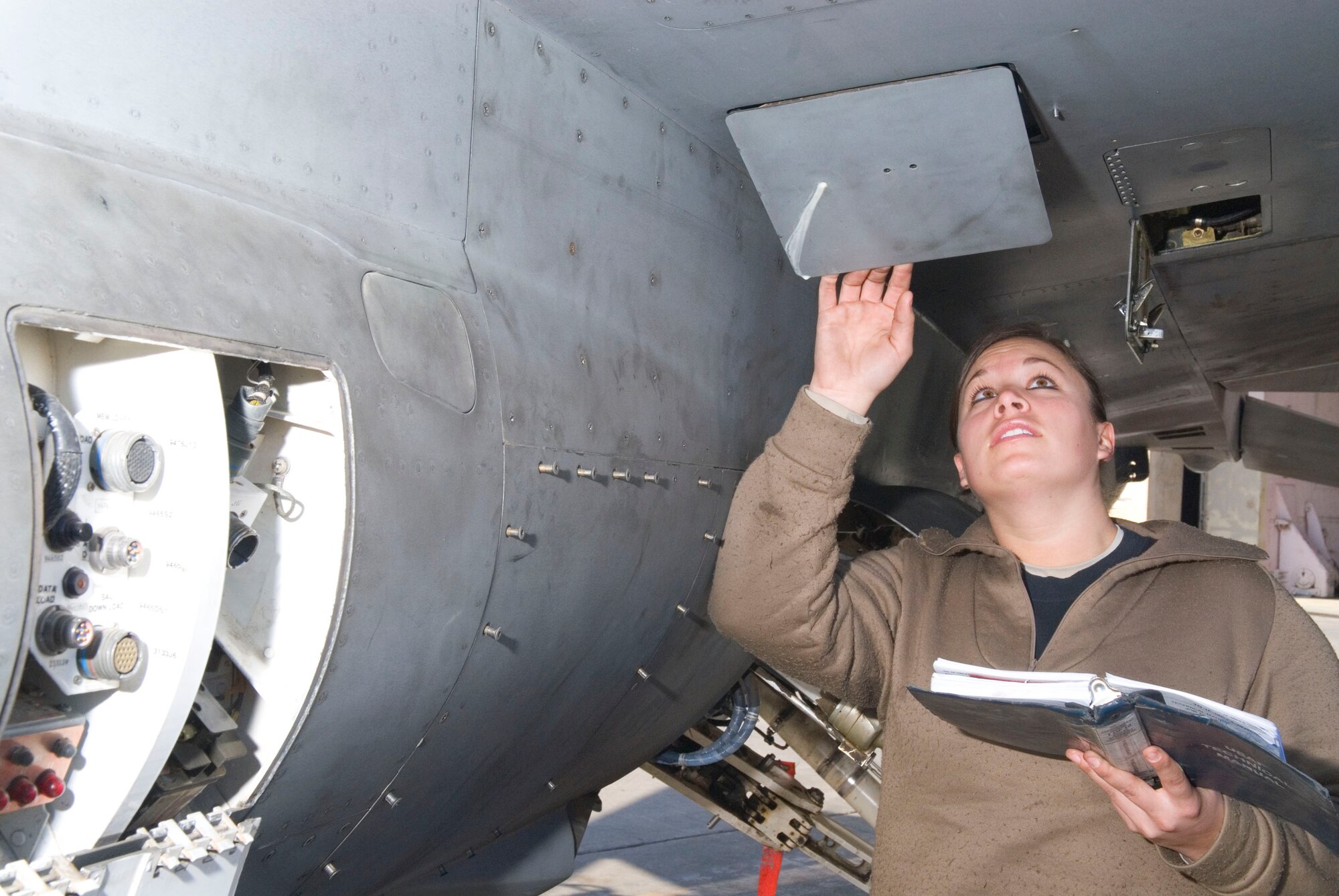 BALAD AIR BASE, Iraq -- Senior Airman Renee Hoover, a 332nd Expeditionary Aircraft Maintenance Unit crew chief, performs an initial inspection on an F-16 Fighting Falcon during a personnel evaluation here, Jan. 17. Personnel evaluations occur annually and within 60 days of an Airman joining a maintenance unit. Airman Hoover is deployed from Spangdahlem Air Base, Germany. (U.S. Air Force photo/Staff Sgt. Joshua Garcia)