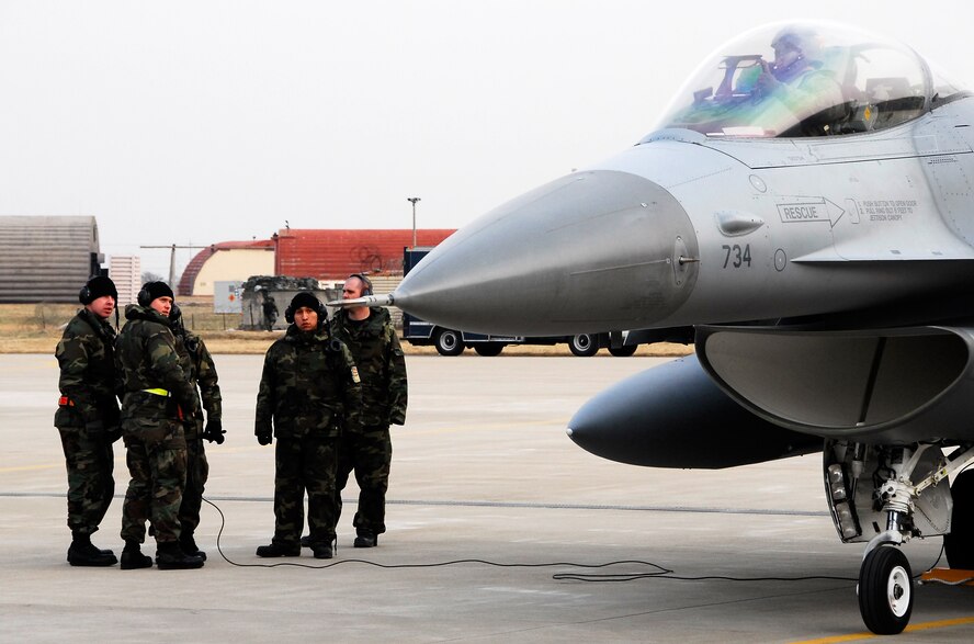 KUNSAN AIR BASE, South Korea -- Members of the 8th Aircraft Maintenance Squadron discuss in-flight errors with an 80th Fighter Squadron F-16 pilot after landing a F-16 Block 40 jet from Eielson Air Base, Alaska here Jan 18.  The 80th FS will be receiving 18 Common Configuration Implementation Program Block 40 jets from the Alaskan based unit and Eielson will in-turn receive the 80th FS Block 30 jets for an aggressor squadron.  (U.S. Air Force photo/Tech Sgt. Quinton T. Burris)