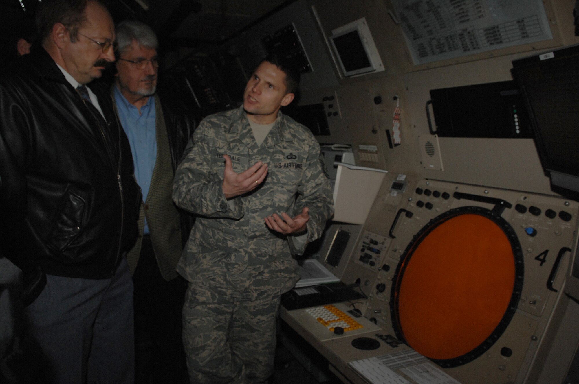 Master Sgt. Howard Teesdale, 86th Operation Support Squadrons, explains to visitors from local air sport clubs how the Ground Controlled Approach (GCA) works on Jan. 16. The local nationals were visiting to discuss issues with air traffic in the Rheinland-Pfalz area. (U.S. Air Force photo by Airman 1st Class Amber Bressler)(RELEASED)