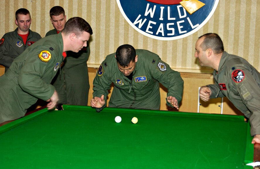 MISAWA AIR BASE, Japan -- Col. Mark Altobelli, 35th Operations Group, tries to block Capt. Charles Fallon and Lt. Col. John Bobroski during the 35th Fighter Wing Crud Tournament here on Jan. 11, 2008. If the ball stops before the player is able to hit it with the cue ball that player gets a strike. (U.S. Air Force photo by Senior Airman Eric J. Harris)
