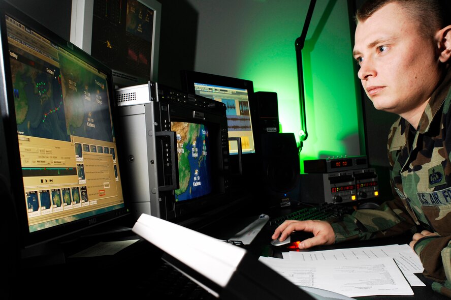Staff Sgt. Brandon Proctor, a weather broadcast technician at the American Forces News Weather Center on Offutt Air Force Base, Neb., builds graphical animation for the Pacific Region report. (Photo by G. A. Volb)