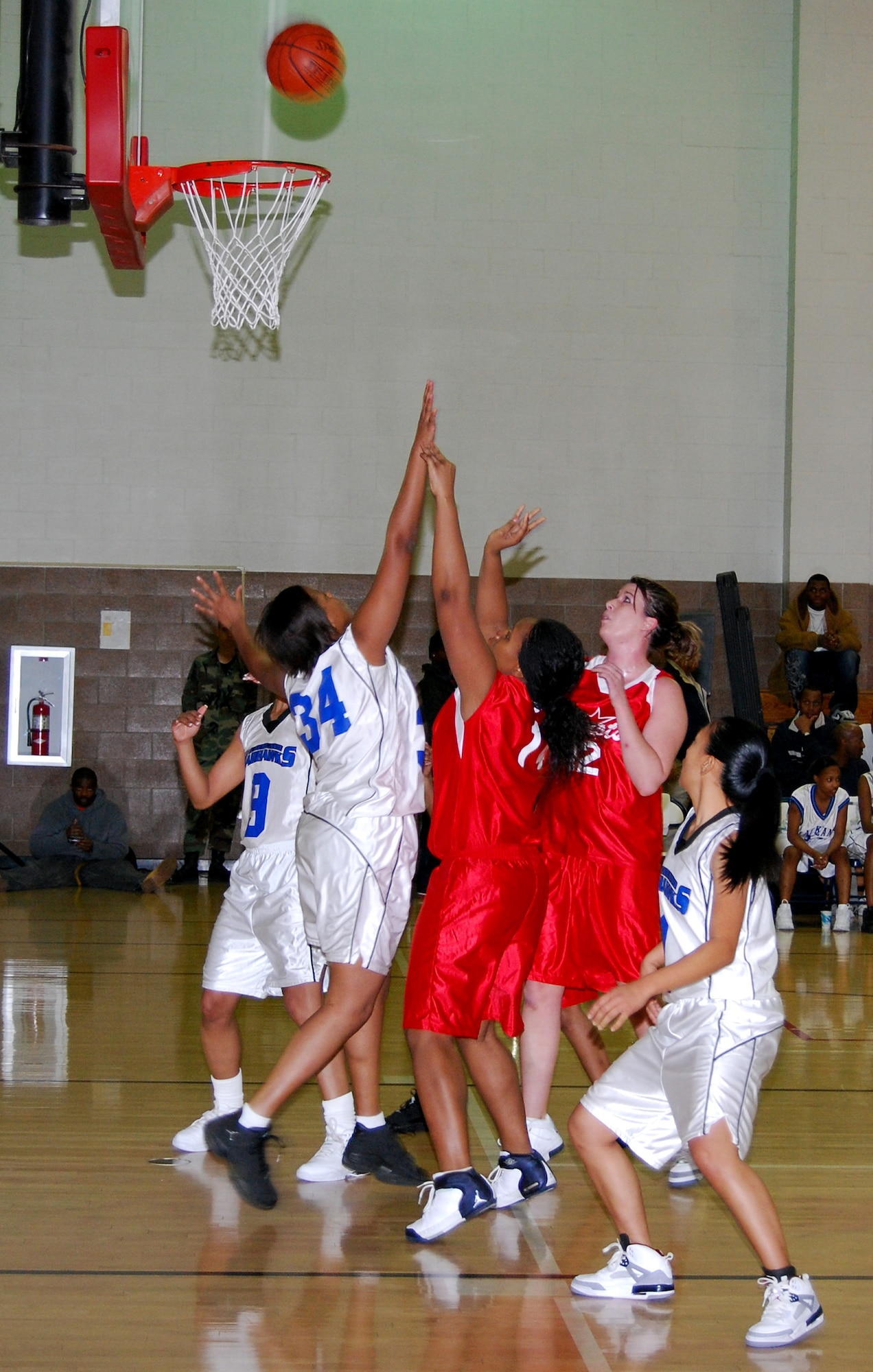 Latisha Copeland, red, from Altus Air Force Base, Okla., puts up a shot over Mel Gibson, during the women's bracket opening game of the 2008 Dr. Martin Luther King Jr. basketball tournament Jan. 19. The Lackland Lady Warhawks beat the Altus Lady Patriots, 43-40. (U.S. Air Force photo/John Ingle)