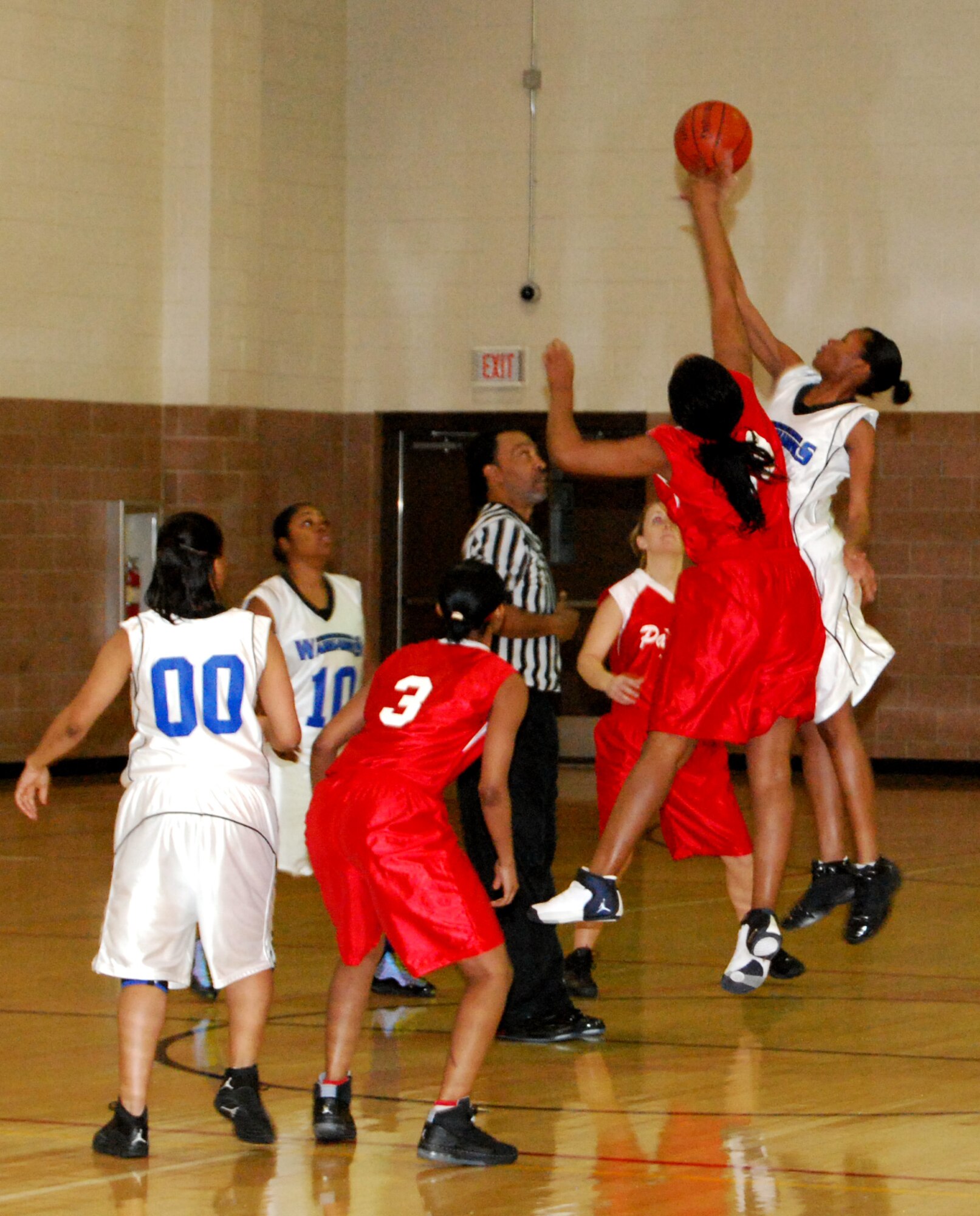 April Copeland (red) from Altus Air Force Base, Okla., and Allendra Taylor from Lackland AFB, Texas, tip off the 2008 Dr. Martin Luther King Jr. women's bracket Jan. 19 during the first contest of the tournament. Lackland overcame a halftime defecit to win the game, 43-40. (U.S. Air Force photo/John Ingle)