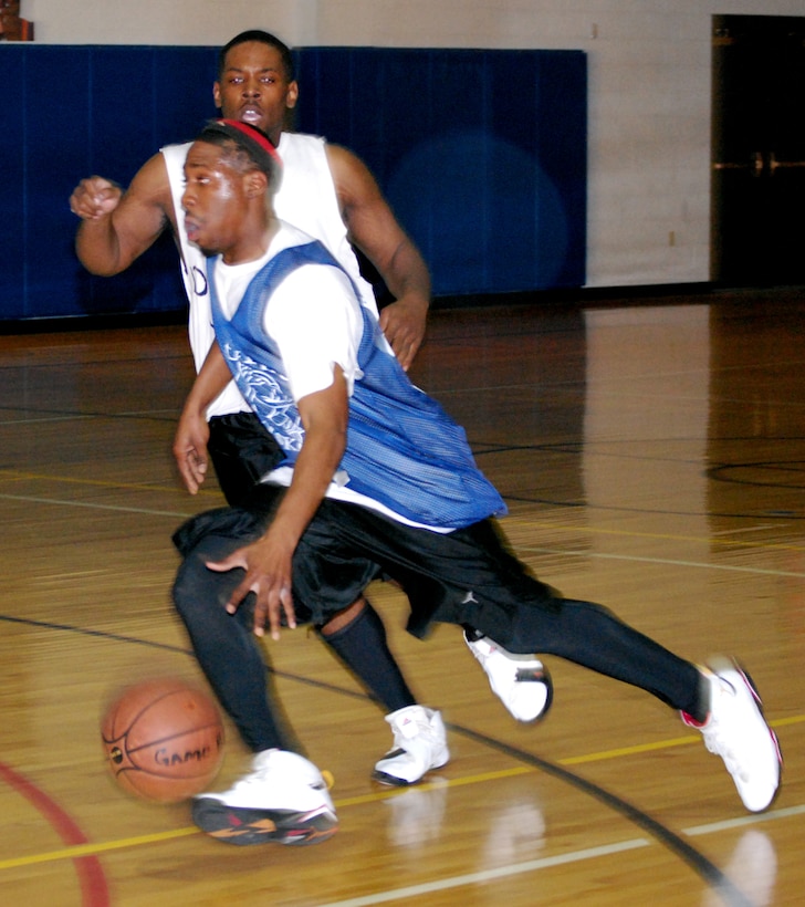 George Brooks of All Kutz drives around Quincy Broughton  Jan. 18 during the open game of the 2008 Dr. Martin Luther King basketball tournament. All Kutz beat the Altus Dream Team 88-84. (U.S. Air Force photo/John Ingle)