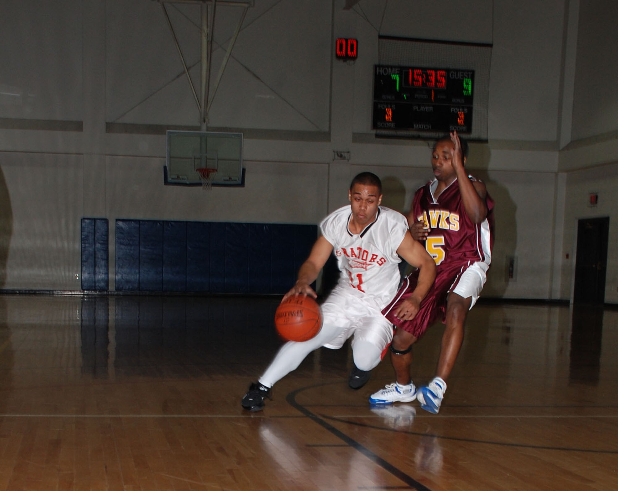 Sheppard Senator's Rod Martin tries to slip past Ronald Perry of the Tinker Air Force Base Hawks during the annual Dr. Martin Luther King Jr. tournament Jan. 19. The Senators defeated the Hawks, 86-73. (U.S. Air Force photo/Airman 1st Class Jacob Corbin)