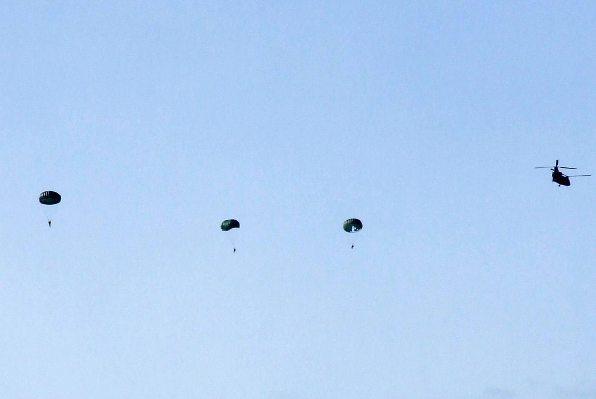 Soldiers from the 404th Civil Affairs Battalion, Fort Dix, N.J., parachute from a CH-47 Chinook from Detachment 1, Company G, 104th Aviation Battalion of the Connecticut Army National Guard at Windsor Locks, over Naval Air Engineering Station Lakehurst, N.J., as part of an event for Air Force Exercise Eagle Flag 08-2 Jan. 16, 2007.  The effort was for a joint operations event for the exercise.  The exercise is operated by the U.S. Air Force Expeditionary Center's 421st Combat Training Squadron at Fort Dix.  (U.S. Air Force Photo/Tech. Sgt. Scott T. Sturkol)
