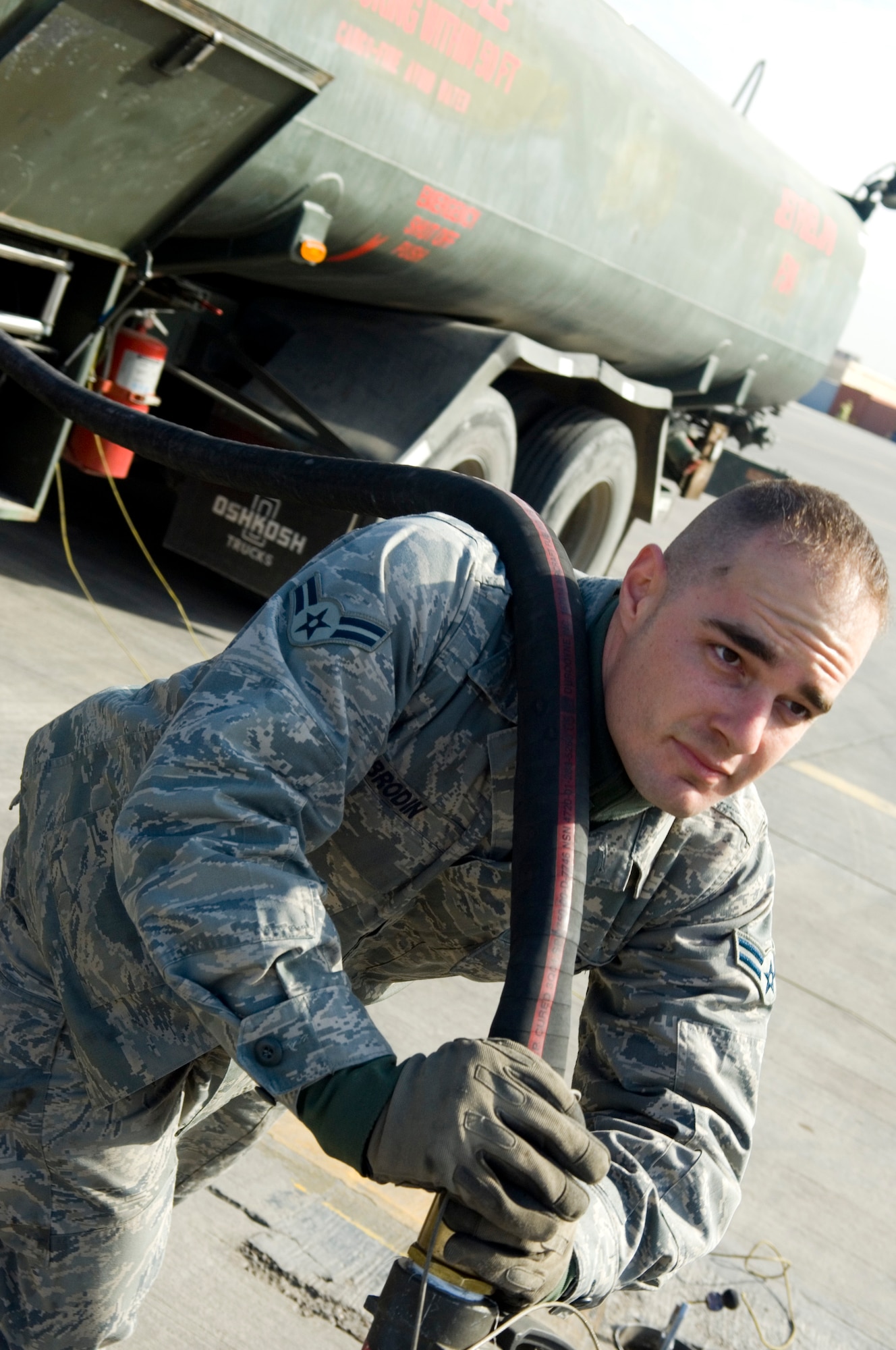 BALAD AIR BASE, Iraq -- Airman 1st Class Shaun Brodin, a 332nd Expeditionary Logistics Readiness Squadron fuels distribution operator, pulls out a fuel line to fill up a C-12 Huron here, Jan. 19. Airman Brodin and seven other Airmen in his shop pumped more than one million gallons of JP-8 fuel while deployed. Airman Brodin is deployed from Little Rock Air Force Base, Ark. (U.S. Air Force photo/ Staff Sgt. Travis Edwards)