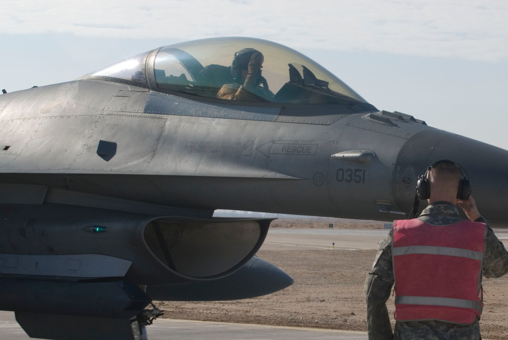 BALAD AIR BASE, Iraq -- Staff Sgt. Jeremy Lewis, a 332nd Expeditionary Aircraft Maintenance Unit crew chief, salutes Capt. Travis "Bandit" Keenan, a 22nd Expeditionary Fighter Squadron pilot, after having his aircraft disarmed here, Jan. 19. Sergeant Lewis and Captain Keenan are deployed from Spangdahlem Air Base, Germany. (U.S. Air Force photo/Staff Sgt. Joshua Garcia)