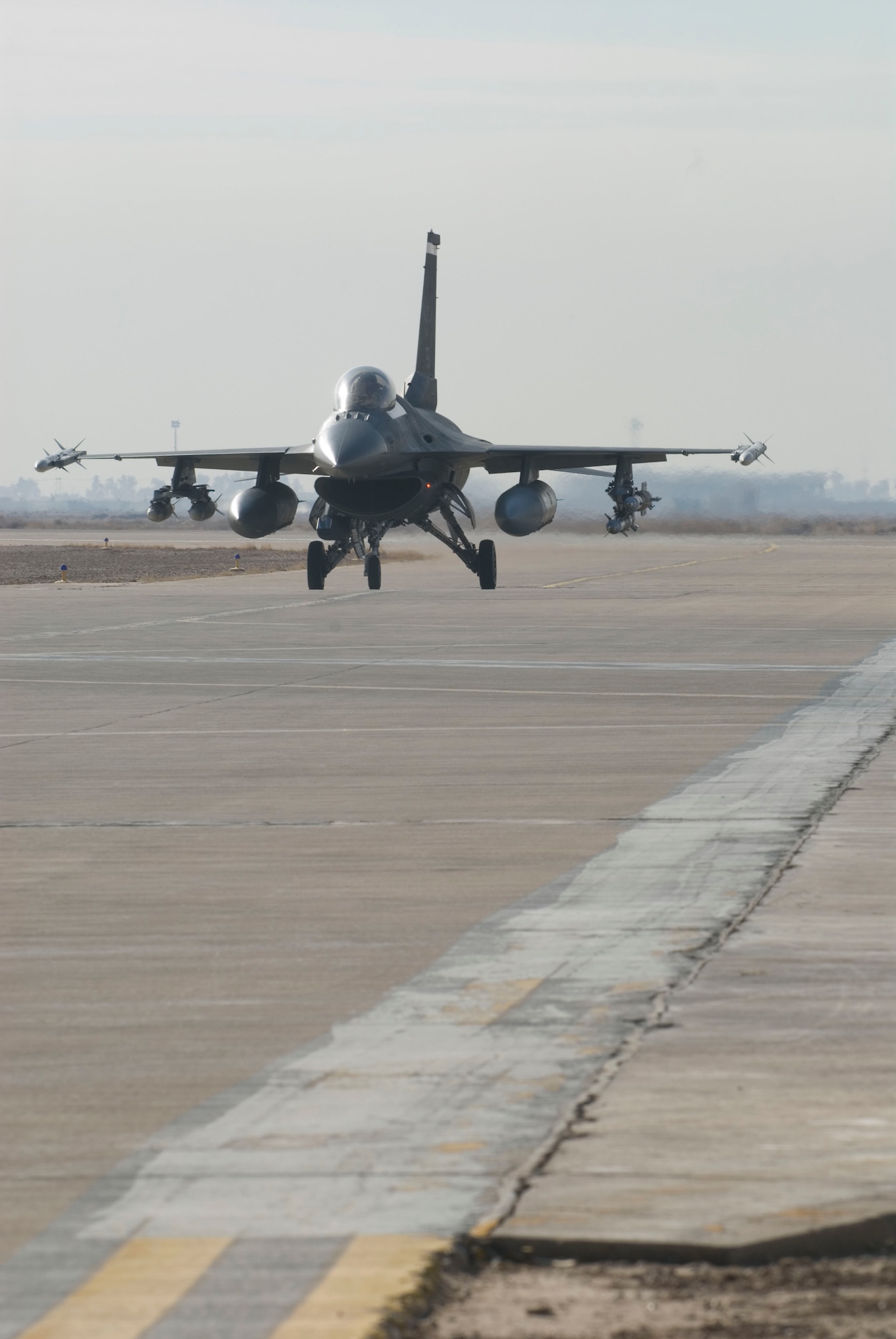 BALAD AIR BASE, Iraq -- An F-16 Fighting Falcon from the 22nd Expeditionary Fighter Squadron taxis from the runway to a secure area to disarm here, Jan. 19. Munitions are de-armed prior to returning to a hardened aircraft shelter to ensure the safety of ground personnel.  (U.S. Air Force photo/Staff Sgt. Joshua Garcia)