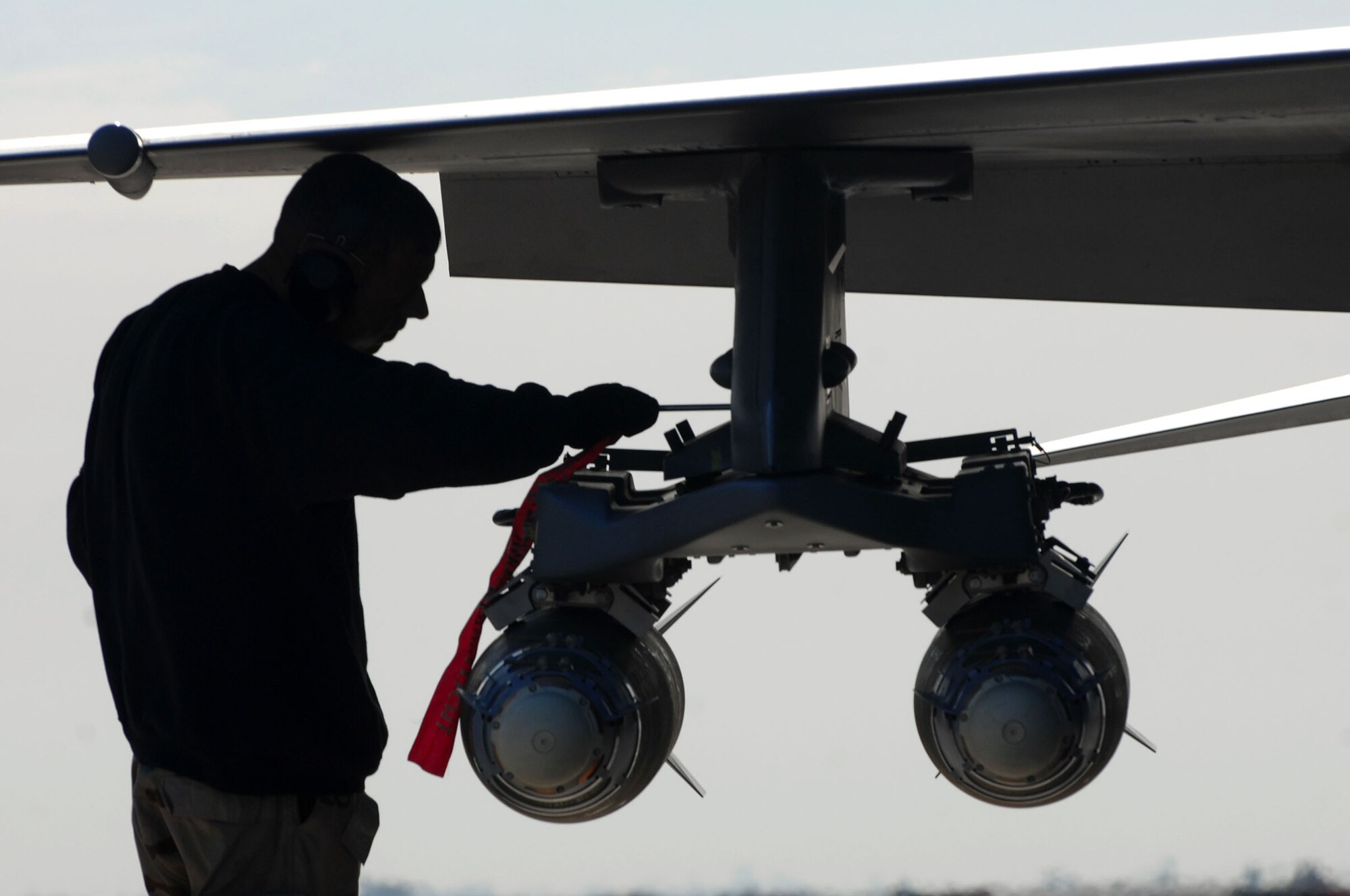 BALAD AIR BASE, Iraq -- Staff Sgt. Chadwick Carter, a 332nd Aircraft Maintenance Unit weapons loader, inserts an arm-disarm pin into munitions on an F-16 Fighting Falcon here, Jan. 19. Sergeant Carter is deployed from Spangdahlem Air Base, Germany. (U.S. Air Force photo by Senior Airman Julianne Showalter) 