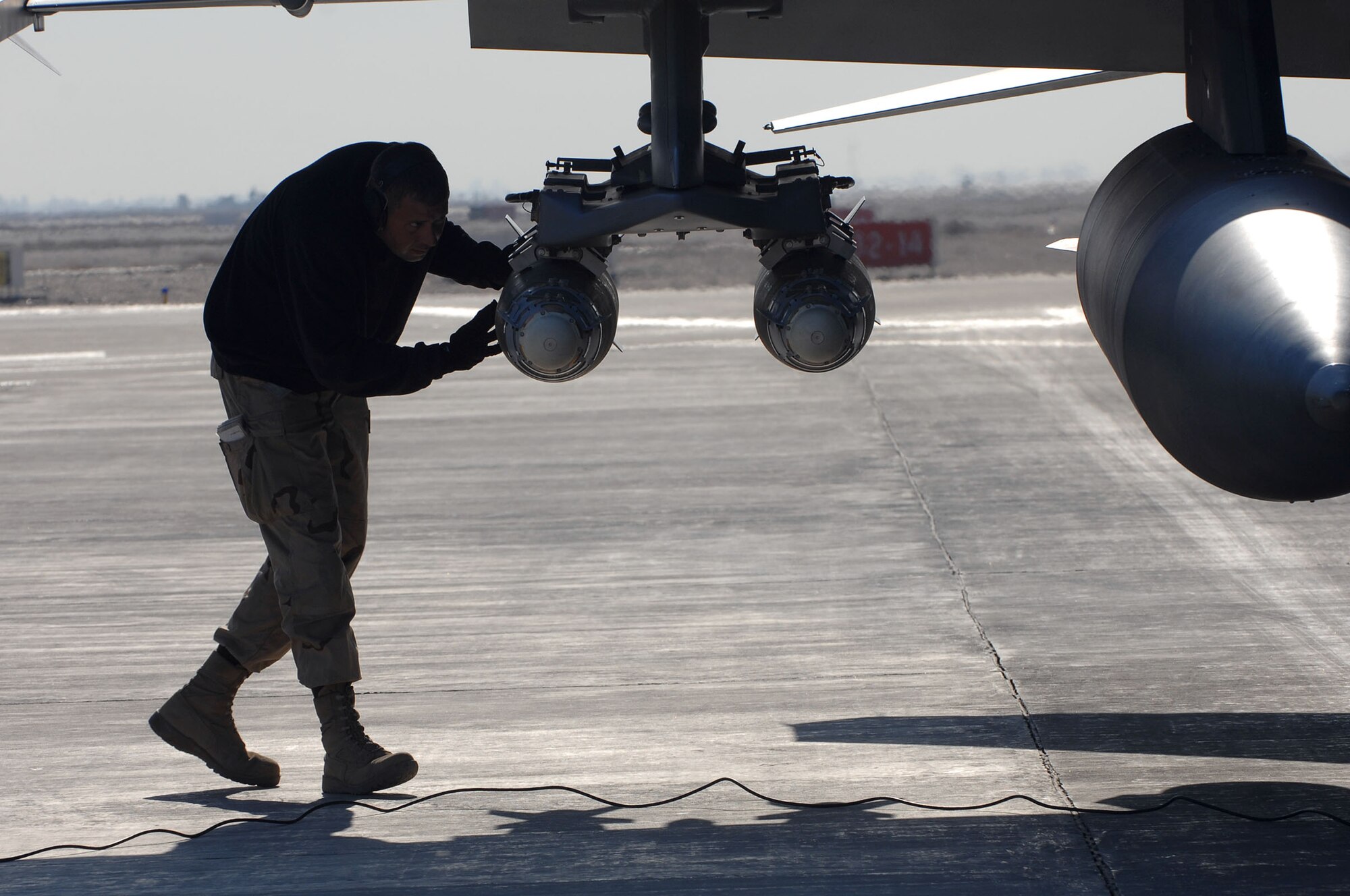 BALAD AIR BASE, Iraq -- Staff Sgt. Chadwick Carter, a 332nd Aircraft Maintenance Unit weapons loader, disarms a guided bomb unit on an F-16 Fighting Falcon here, Jan. 19. Aircraft munitions are disarmed after landing to ensure the safety of ground personnel. Sergeant Carter is deployed from Spangdahlem Air Base, Germany. (U.S. Air Force photo by Senior Airman Julianne Showalter)