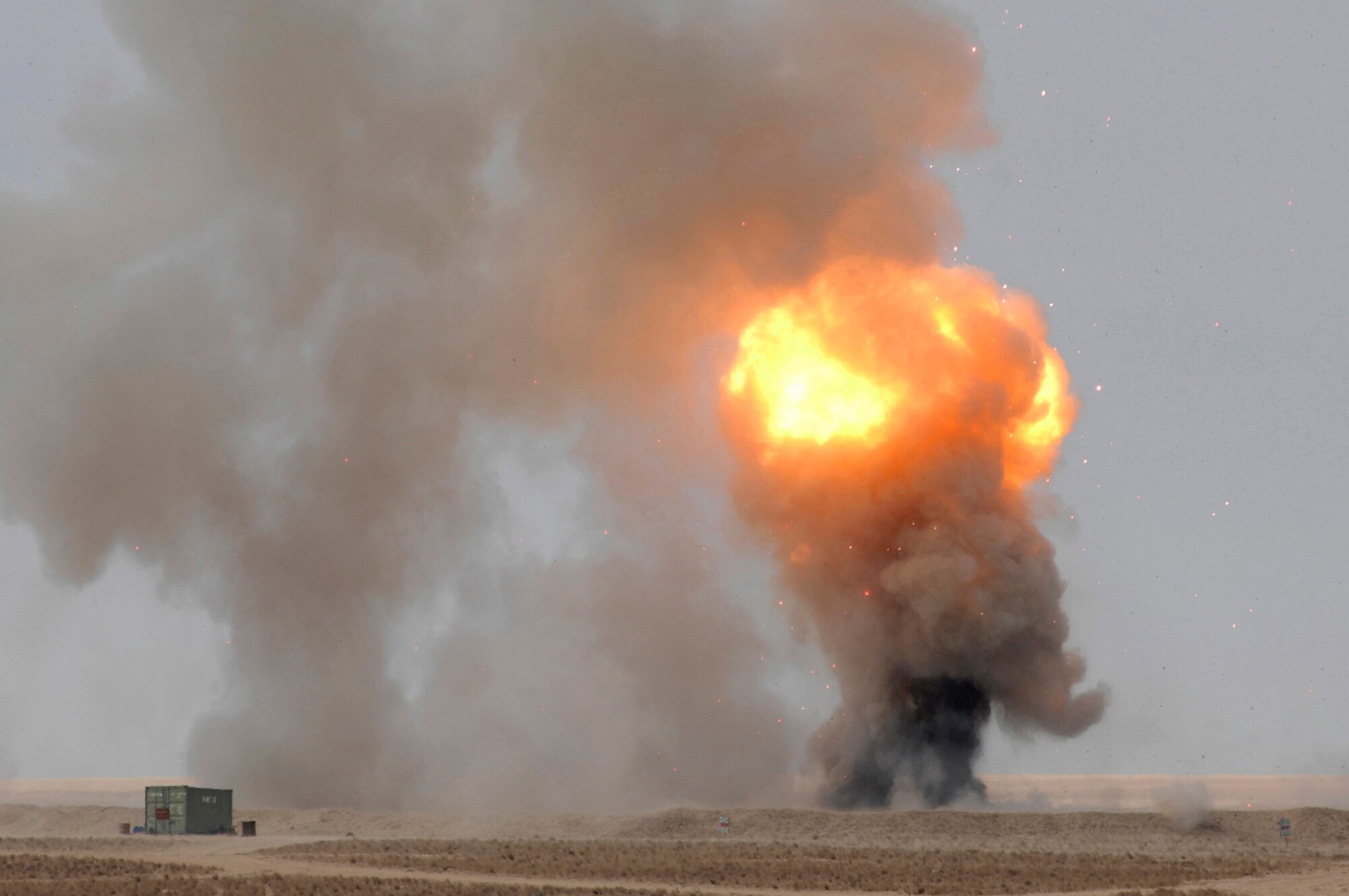 A fire ball rises into the sky during a controlled detonation performed by coalition forces from the Air Force's 386th Expeditionary Civil Engineer Squadron and the Australian Army Force Level Logistic Asset Jan. 18 at an explosive ordnance disposal range in the Persian Gulf Region.  The controlled detonation is destroying unserviceable munitions. (U.S. Air Force photo/Senior Airman Patrick Dixon)
