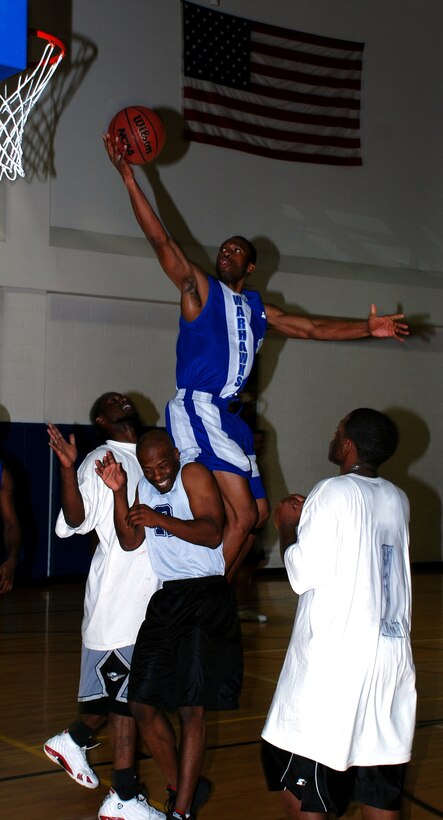 Rodrick Greene from Lackland Air Force Base, Texas, flies to the rim over Altus Dream Team players Jan. 20 during the annual Dr. Martin Luther King Jr. basketball tournament. (Lackland beat Altus 71-57 to advance to the finals against Cannon Air Force Base, N.M. (U.S. Air Force photo/Airman 1st Class Jacob Corbin)