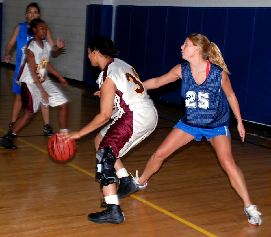 Tiffany Perry from Tinker Air Force Base, Okla., tries to get by Barksdale Air Force Base Lady Bomber Chelsea Roberts during the annual Dr. Martin Luther King Jr. tournament Jan. 20. Barksdale defeated Tinker 56-46. (U.S. Air Force photo/Airman 1st Class Jacob Corbin)