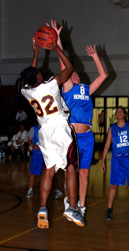 No. 8 Becky Schliter from Barksdale Air Force Base, La., gets set to stuff a Tinker Lady Hawks' shot during the annual Dr. Martin Luther King Jr. basketball tournament Jan. 20. Barksdale defeated Tinker, 56-46. (U.S. Air Force photo/Airman 1st Class Jacob Corbin)