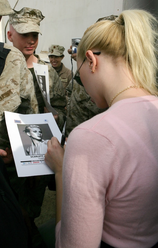 Scarlett Johansson signs an autograph for a fan during a meet and greet Jan. 20 at the United Service Organizations building in Camp Buehring, Kuwait. The 23-year-old bombshell met with nearly 600 service members at Camp Buehring, Kuwait Jan. 20 during her five-day United Service Organizations (USO) tour to the Gulf region.