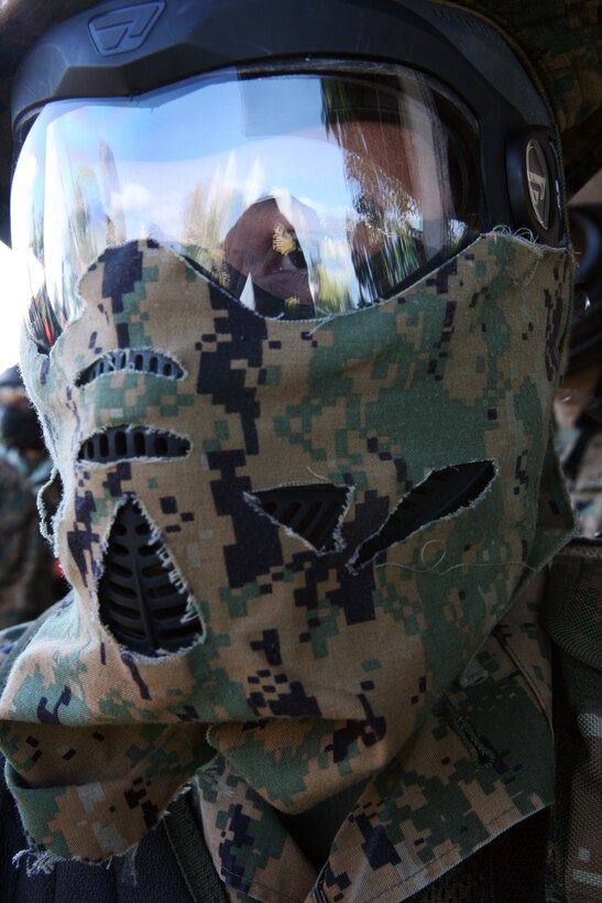 BARBERS POINT, Hawaii -- A Marine member of the Double Tap unit, who goes by the call sign El Diablo, stares through his custom made mask at his opponents before the beginning of an airsoft match held here, Jan. 21.  Many of the members of Double Tap take the sport seriously and have a full arsenal of weapons and gear.