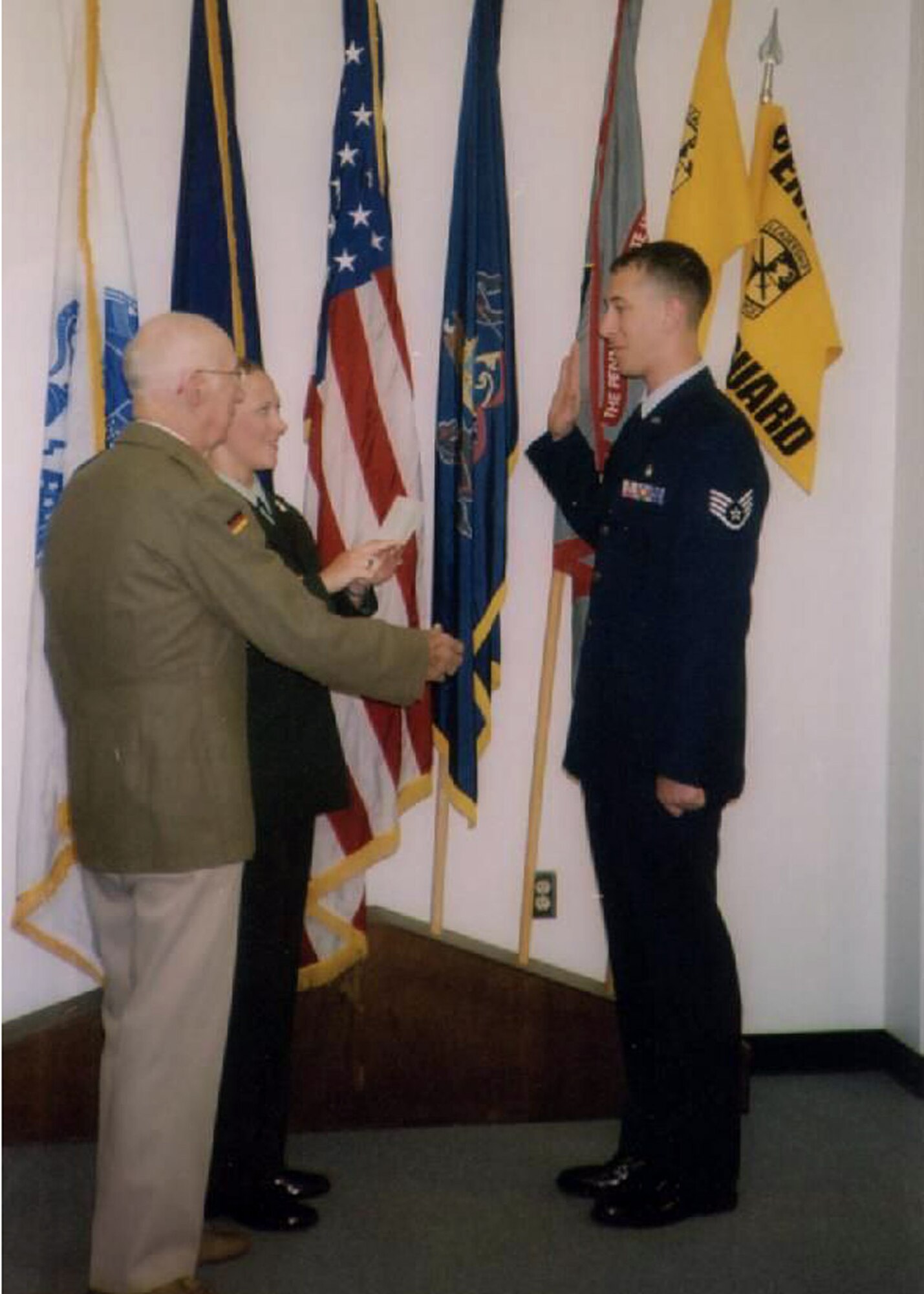 FORT BRAGG, N.C. - Now a captain, former Staff Sgt. Trevor Ambron swears his oath of reenlistment to his sister, Nealy Ambron, U.S. Army, as their grandfather, former U.S. Army Air Corps Capt. Kozlowski looks on. The younger Captain Ambron promised his grandfather he would also one day wear captain’s bars. He fulfilled that promise on Jan. 14, 2008. Captain Ambron deployed from Shaw Air Force Base, S.C., to serve as Provincial Reconstruction Team Gardez’ Physician Assistant. The PRT will deploy early this spring for a year in Afghanistan. (Photo courtesy of Capt. Trevor Ambron)