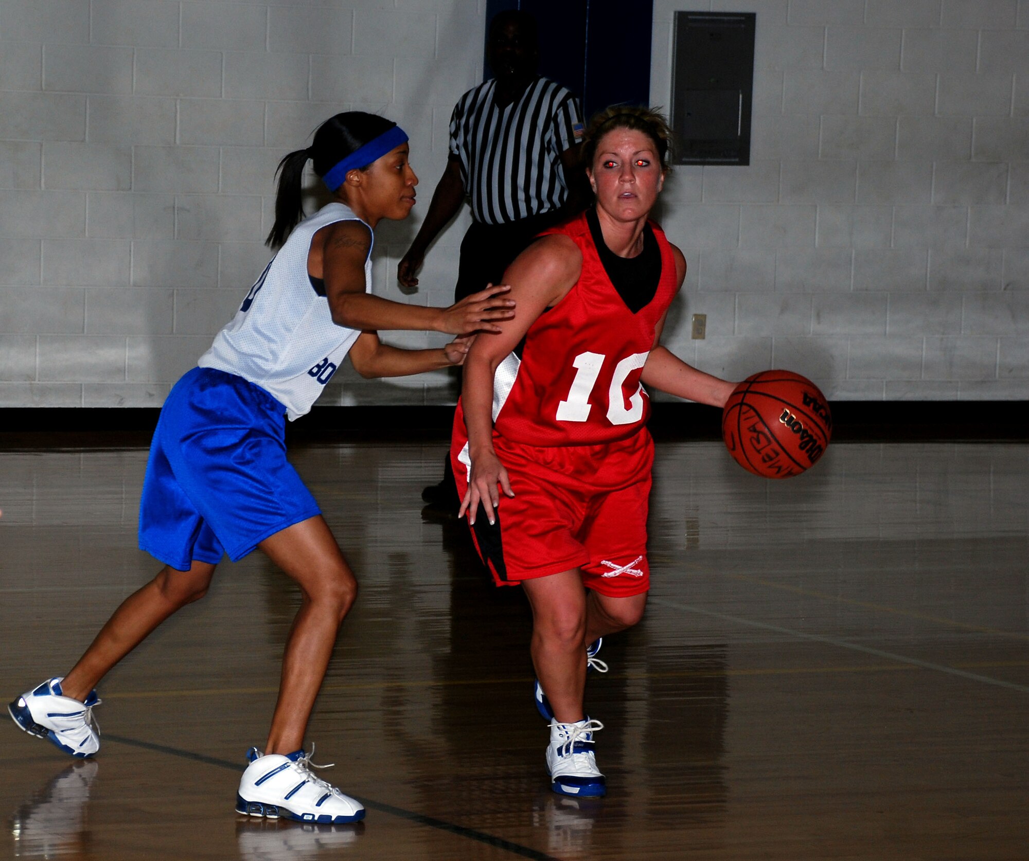 Amanda Cambell of the Fort Sill Lady Cannoneers drives around Barksdale Lady Bomber Keysha Coleman during the 14th Annual Dr. Martin Luther King Jr. basketball tournament Jan. 21 at the Pitsenbarger Fitness Center. Fort Sill defeated the Lady Bombers 69 to 65, winning the womens championship game. (U.S. Air Force photo/Airman 1st Class Jacob Corbin)
