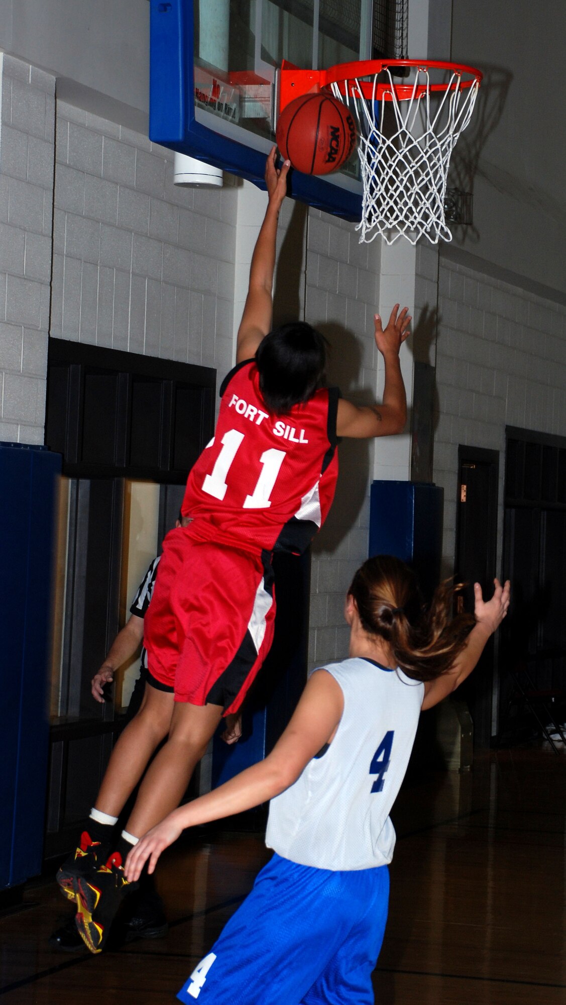 Fort Sill, Okla., Lady Cannoneer Adrian Williams makes a layup over Barksdale Lady Bomber Sarah Brown during the 14th Annual Dr. Martin Luther King Jr. basketball tournament at Sheppard AFB Jan. 21 at the Pitsenbarger Fitness Center. Fort Sill defeated the Barksdale 69 to 65, winning the womens championship game. (U.S. Air Force photo/Airman 1st Class Jacob Corbin)