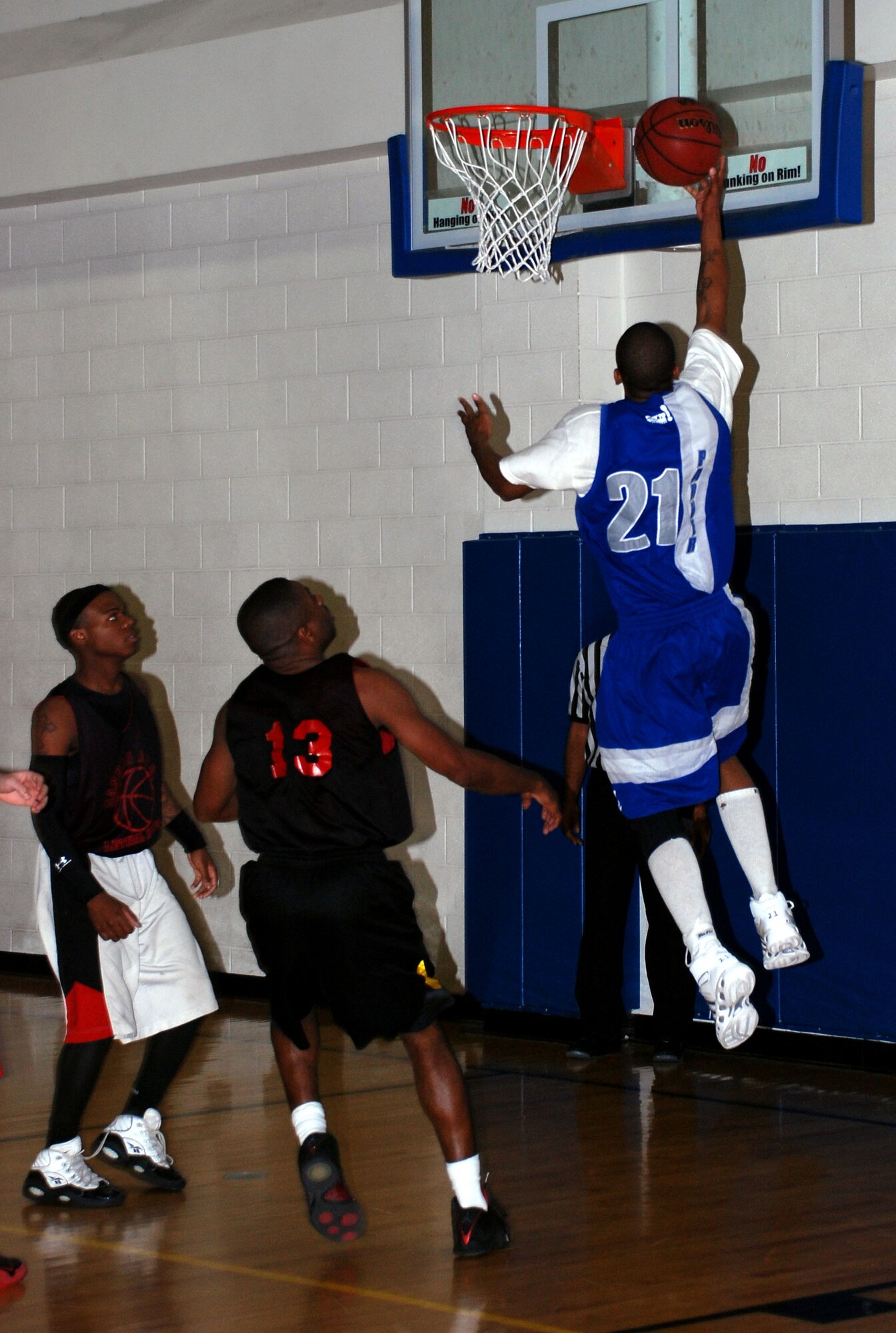 Paul Parker of the Lackland Air Force Base Warhawks makes a layup over Nate Stephens and Stephen Johnson from Cannon Air Force Base, N.M., during the 14th Annual Dr. Martin Luther King Jr. basketball tournament Jan. 21 at the Pitsenbarger Fitness Center. Lackland defeated Cannon Air Force Base twice - 76-50 and 99-79 - to claim the championship. (U.S. Air Force photo/Airman 1st Class Jacob Corbin)