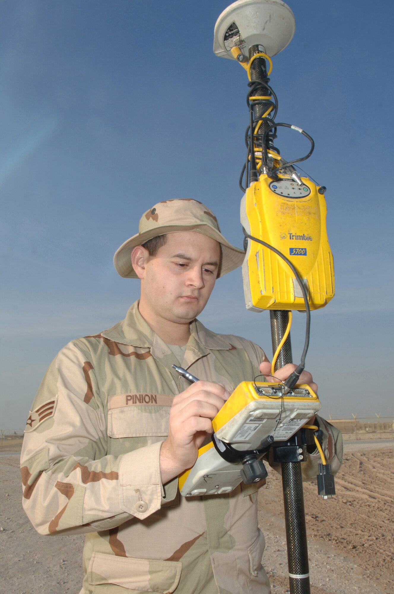 Senior Airman Cody Pinion, 379th Expeditionary Civil Engineer Squadron, prepares a Global Positioning System survey rover to accurately plot unmarked roads for a base map Jan. 17 at a Southwest Asia air base.  Airman Pinion is deployed here from Scott Air Force Base, Ill.  (U.S. Air Force photo/Tech. Sgt. Johnny L. Saldivar)